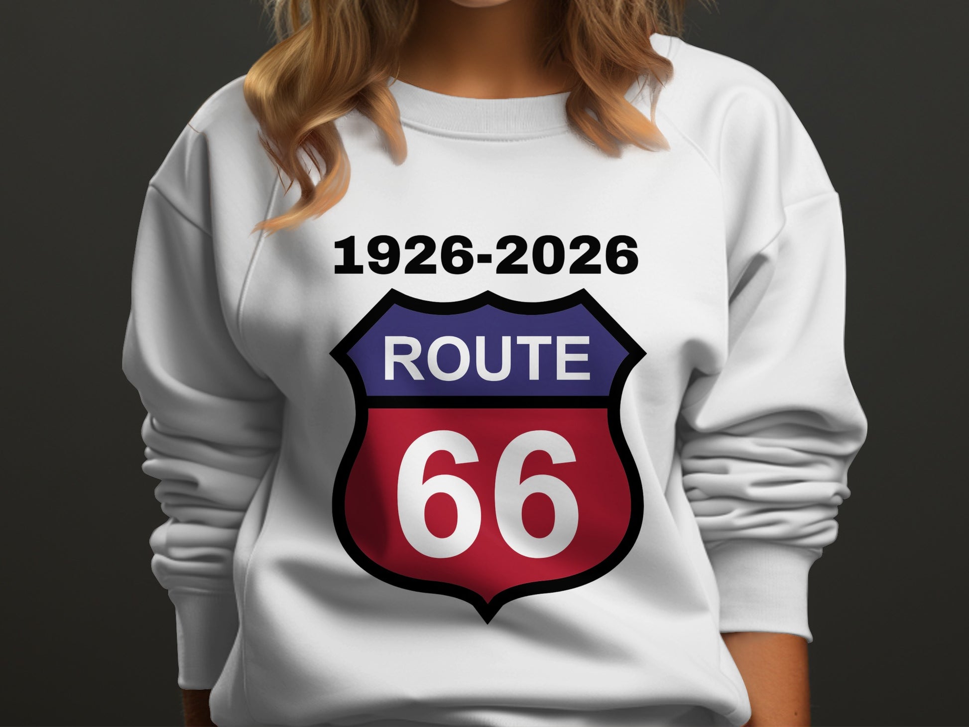 White sweatshirt with a shield logo reading "Route 66 1926-2026".