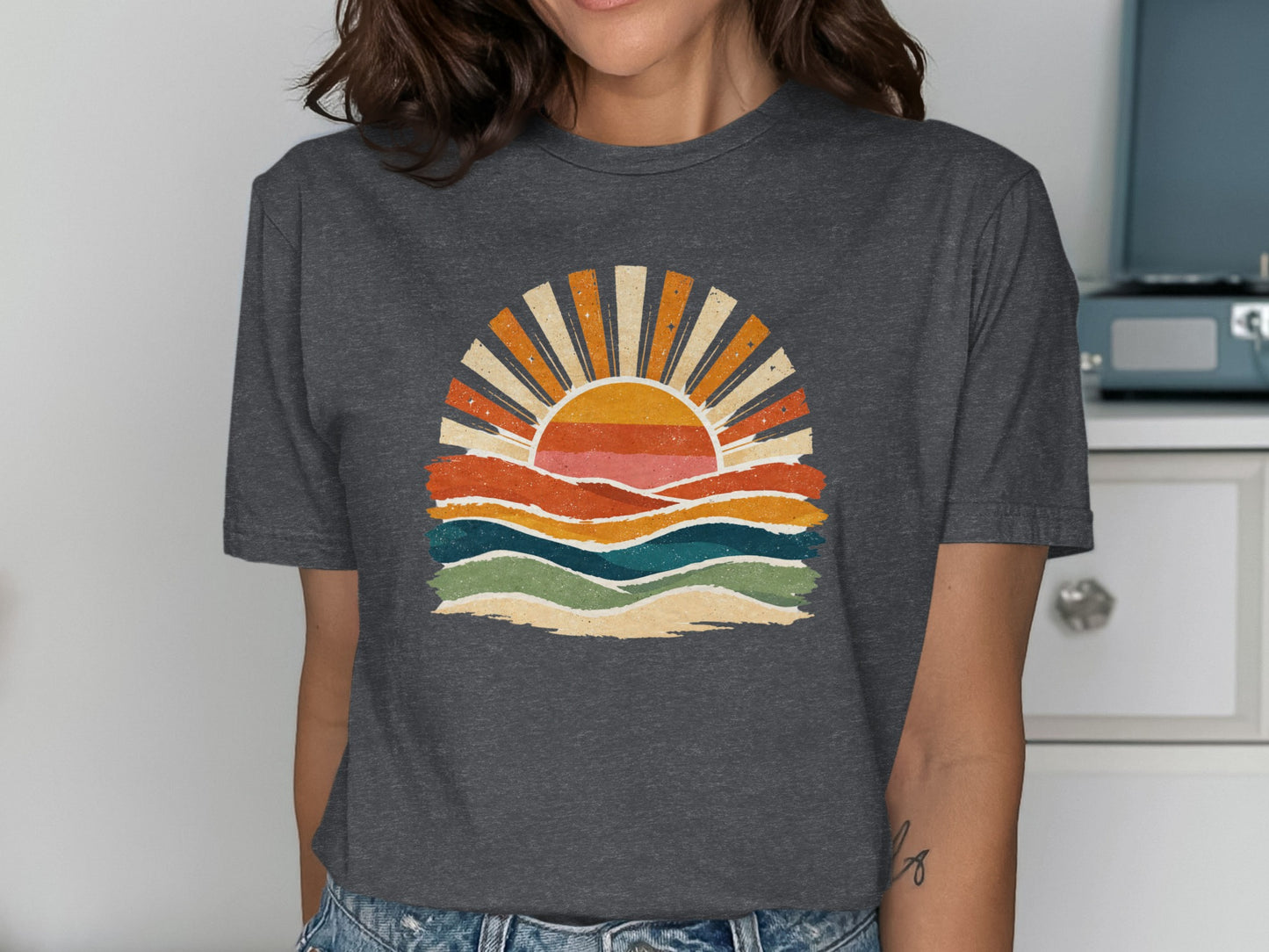 T-shirt graphic of a retro sunset over colorful wavy lines.
