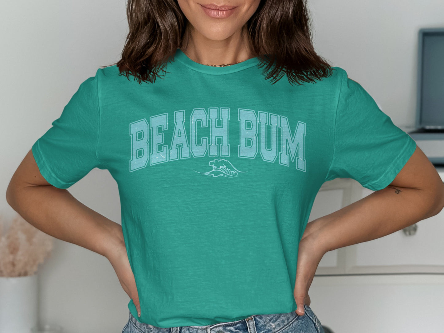 Teal t-shirt with "BEACH BUM" in light blue collegiate font.