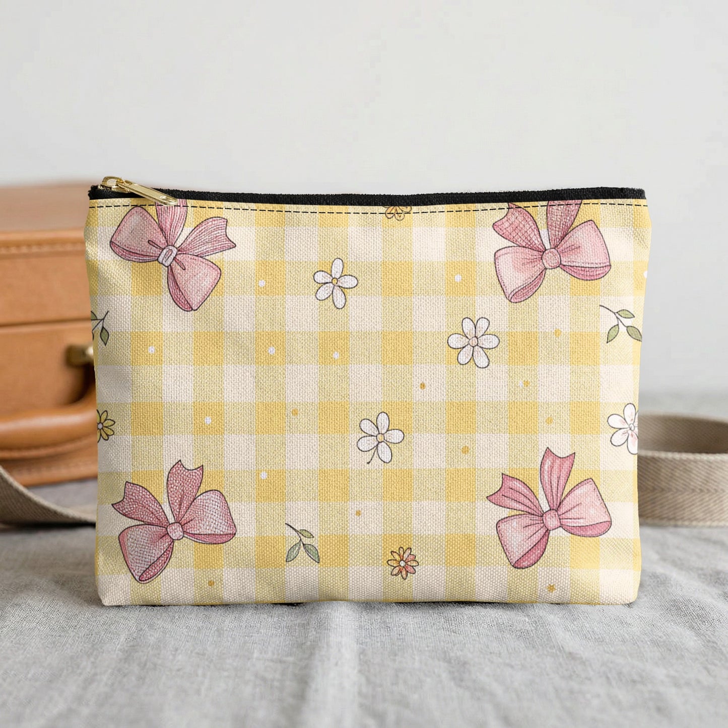 Yellow gingham cosmetic bag with pink bows and scattered flowers.