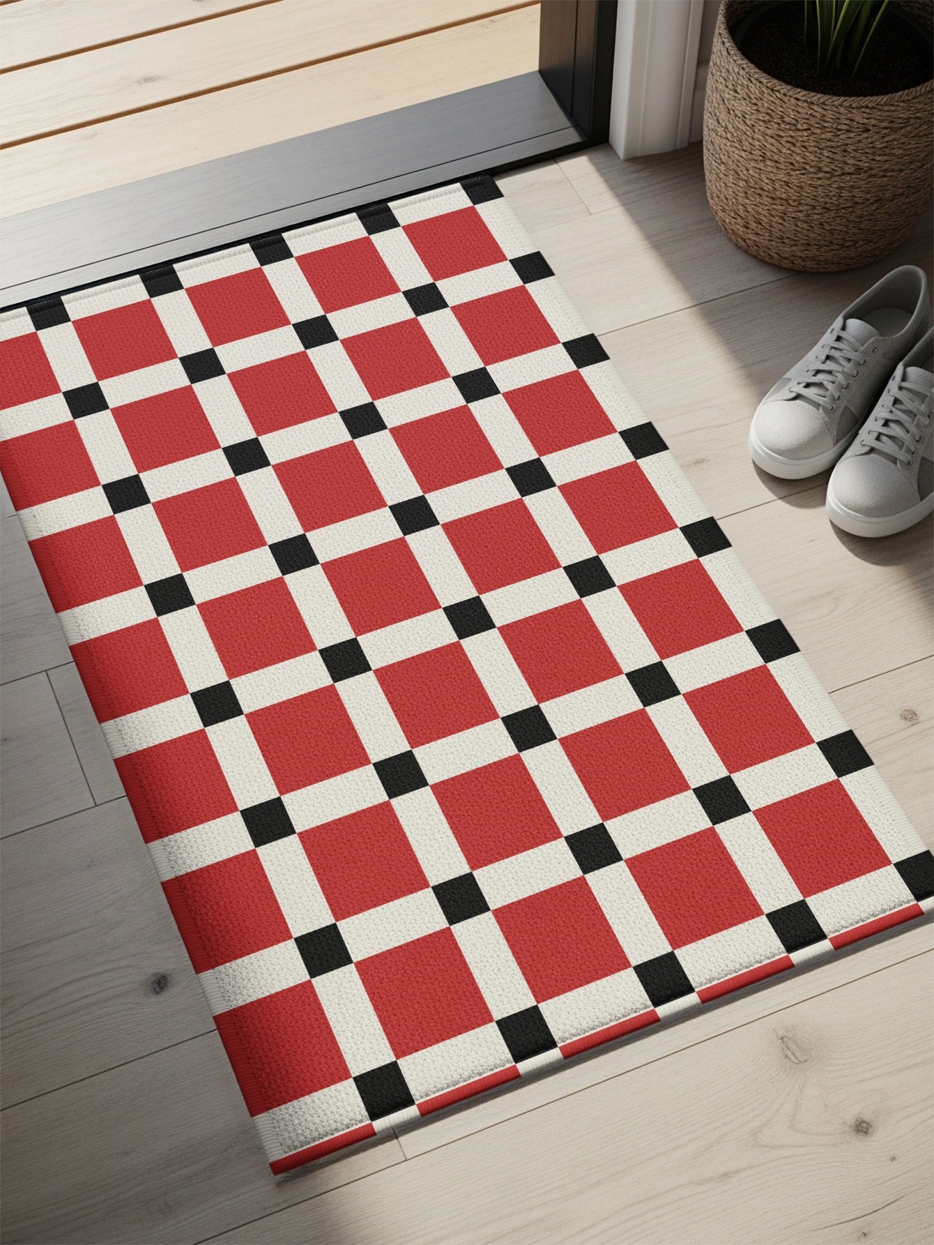 Doormat with a red, white, and black checkered pattern.