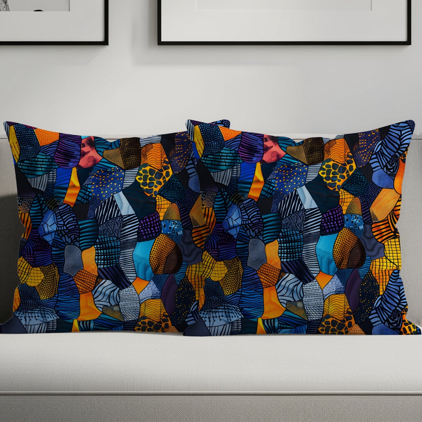 Two lumbar pillows with a colorful patchwork abstract design on a light gray sofa.