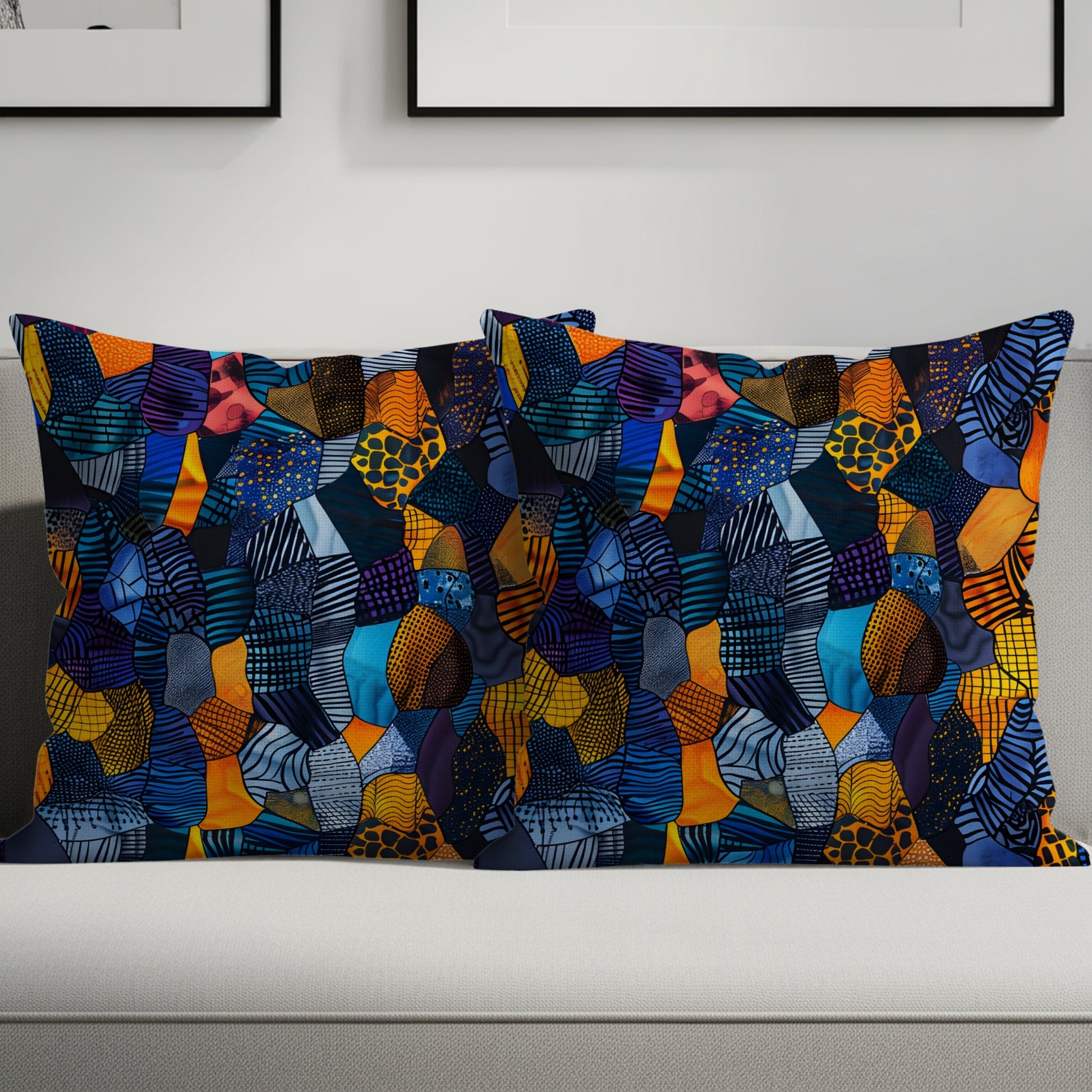 Two lumbar pillows with a colorful patchwork abstract design on a light gray sofa.