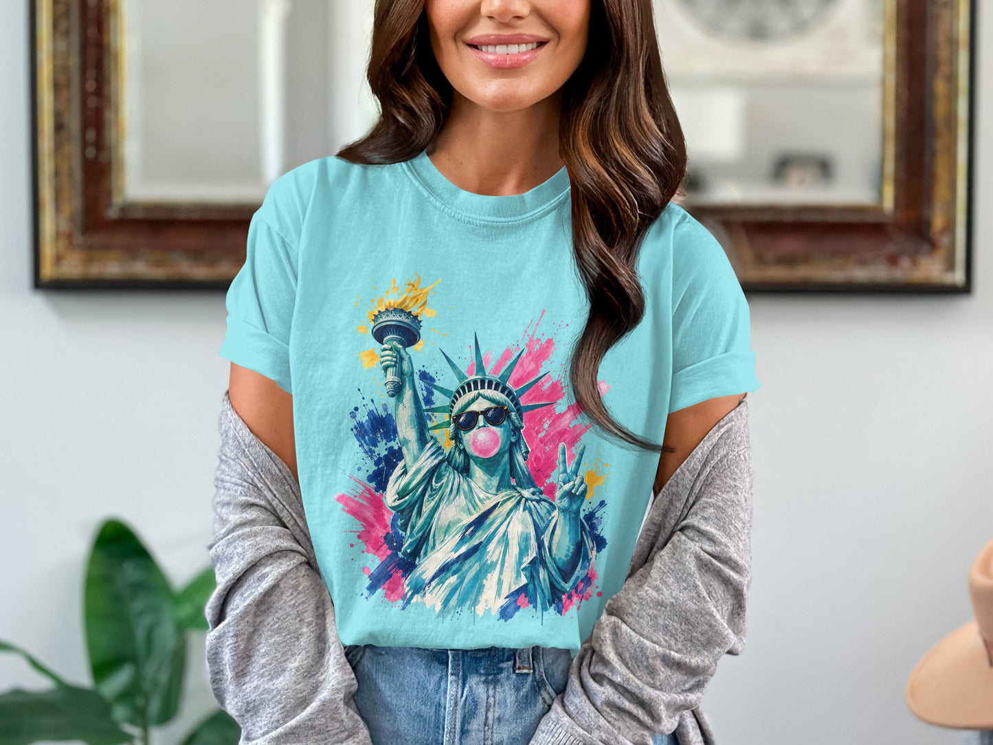 Statue of Liberty wearing sunglasses blowing bubblegum with colorful paint splashes.