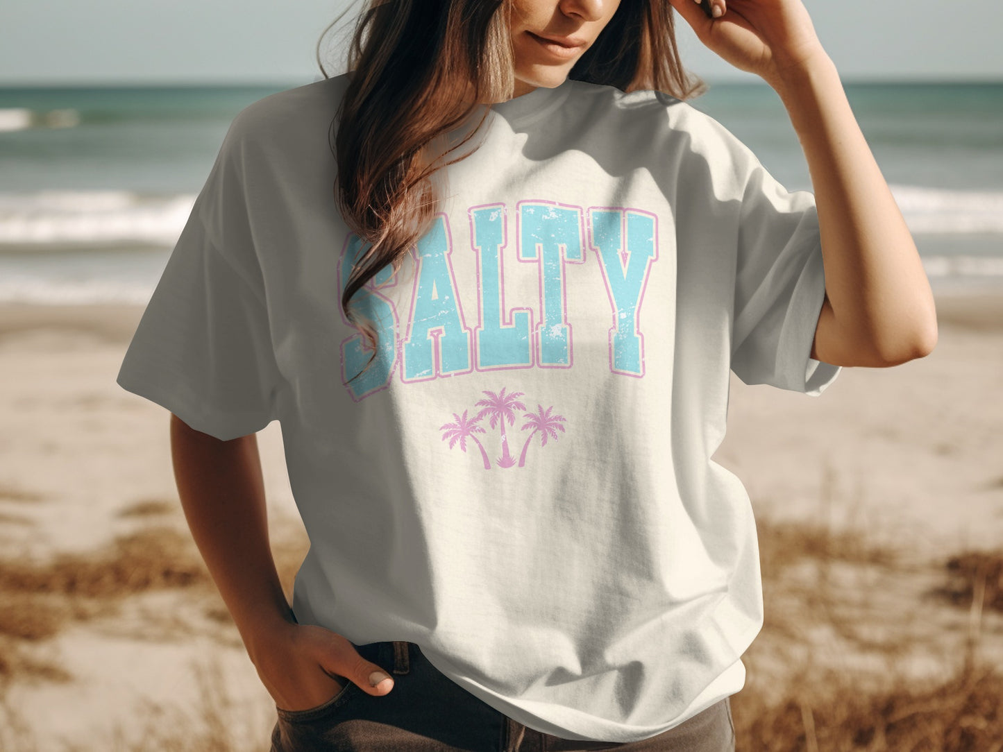 White t-shirt with "SALTY" text and pink palm trees.