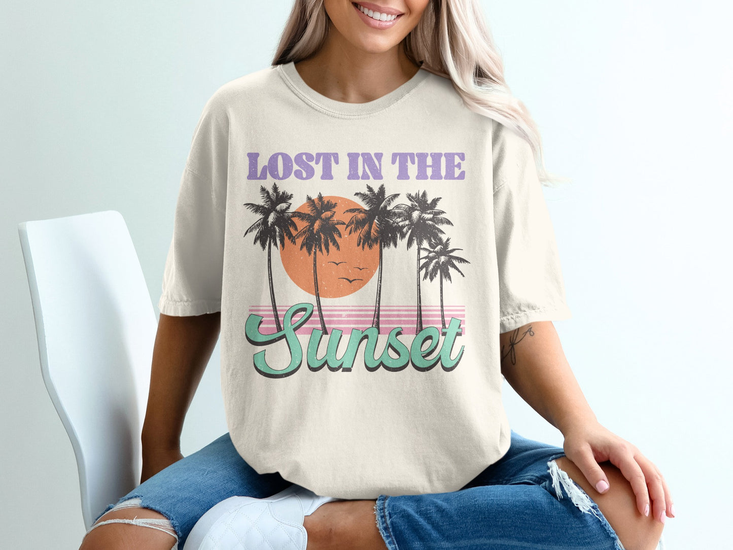Cream t-shirt with "Lost in the Sunset" text and palm trees.