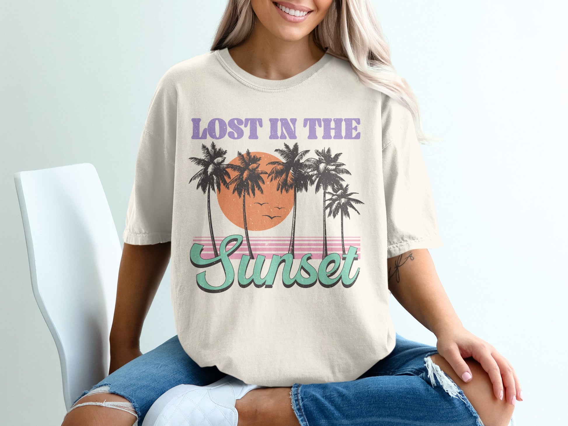 Cream t-shirt with "Lost in the Sunset" text and palm trees.