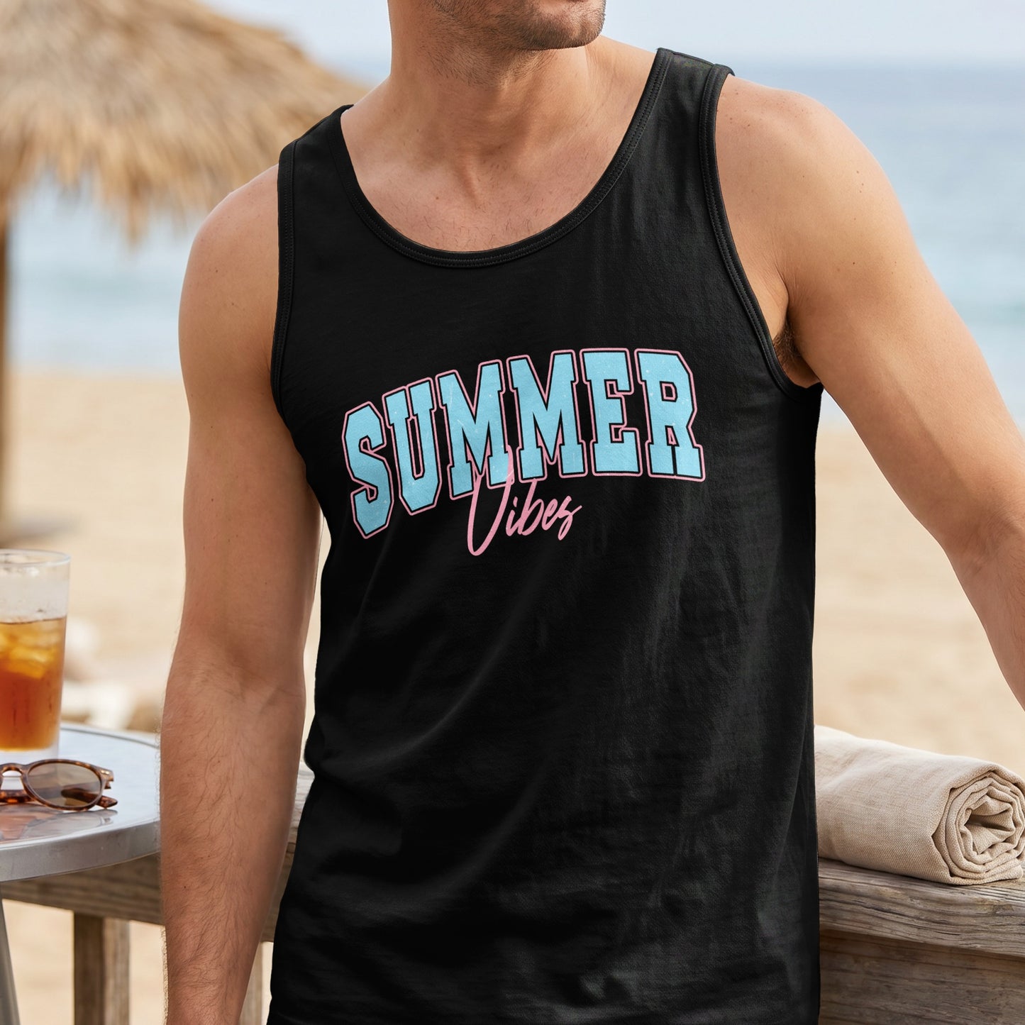 Black tank top with "Summer Vibes" text, worn by a man at the beach.
