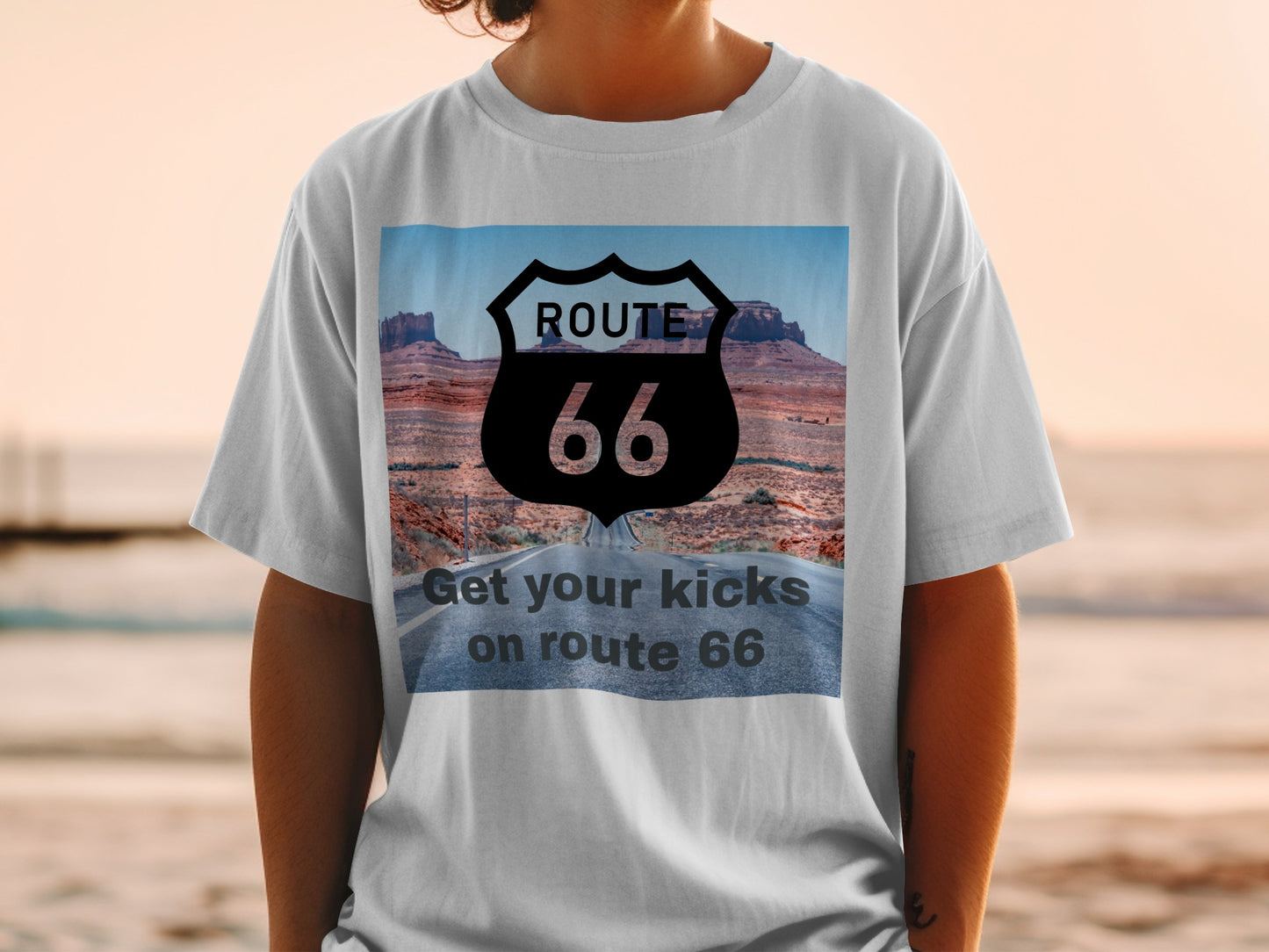White t-shirt with a Route 66 sign and desert road graphic.