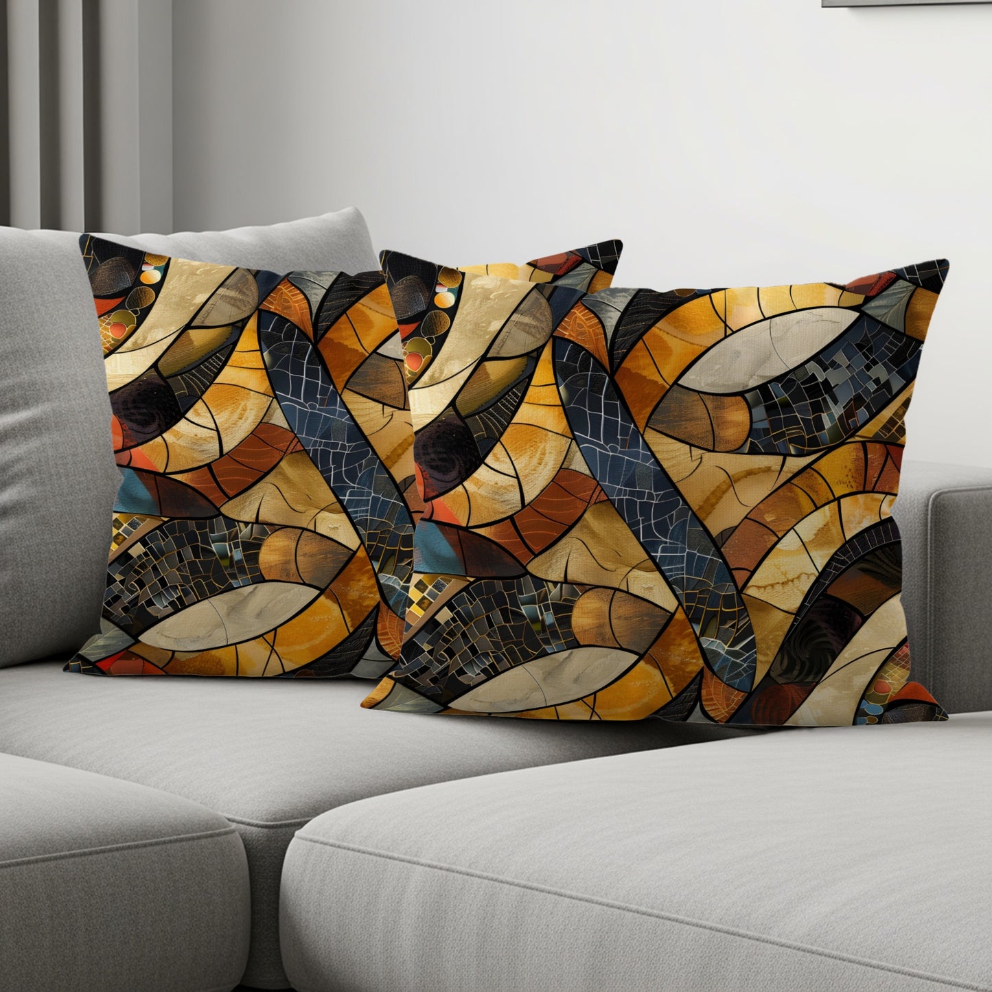 Two throw pillows with a geometric stained-glass pattern in warm colors on a sofa.