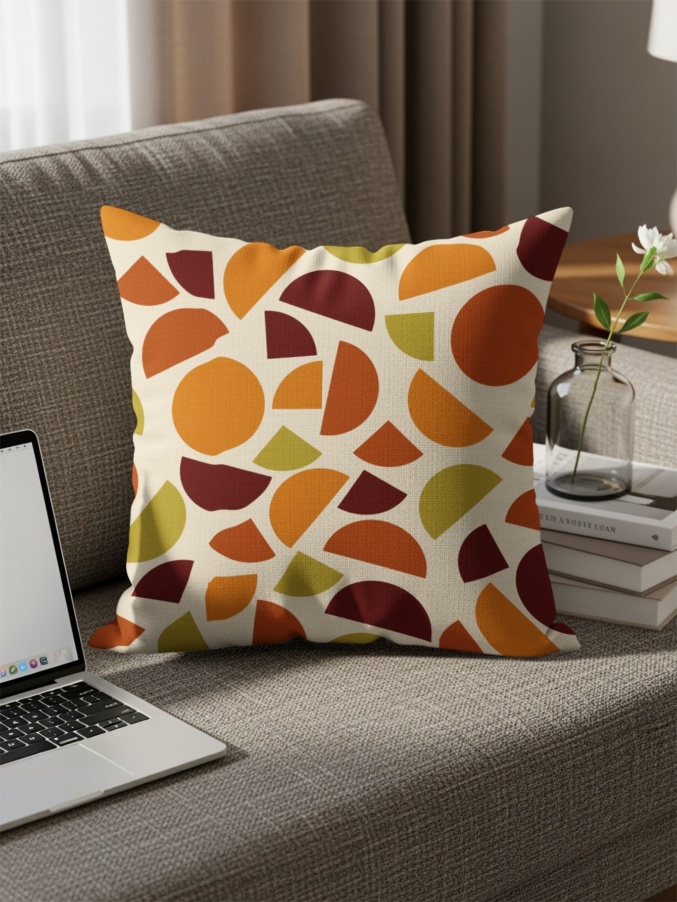 Cushion with organic geometric pattern in orange, rust, and olive green.
