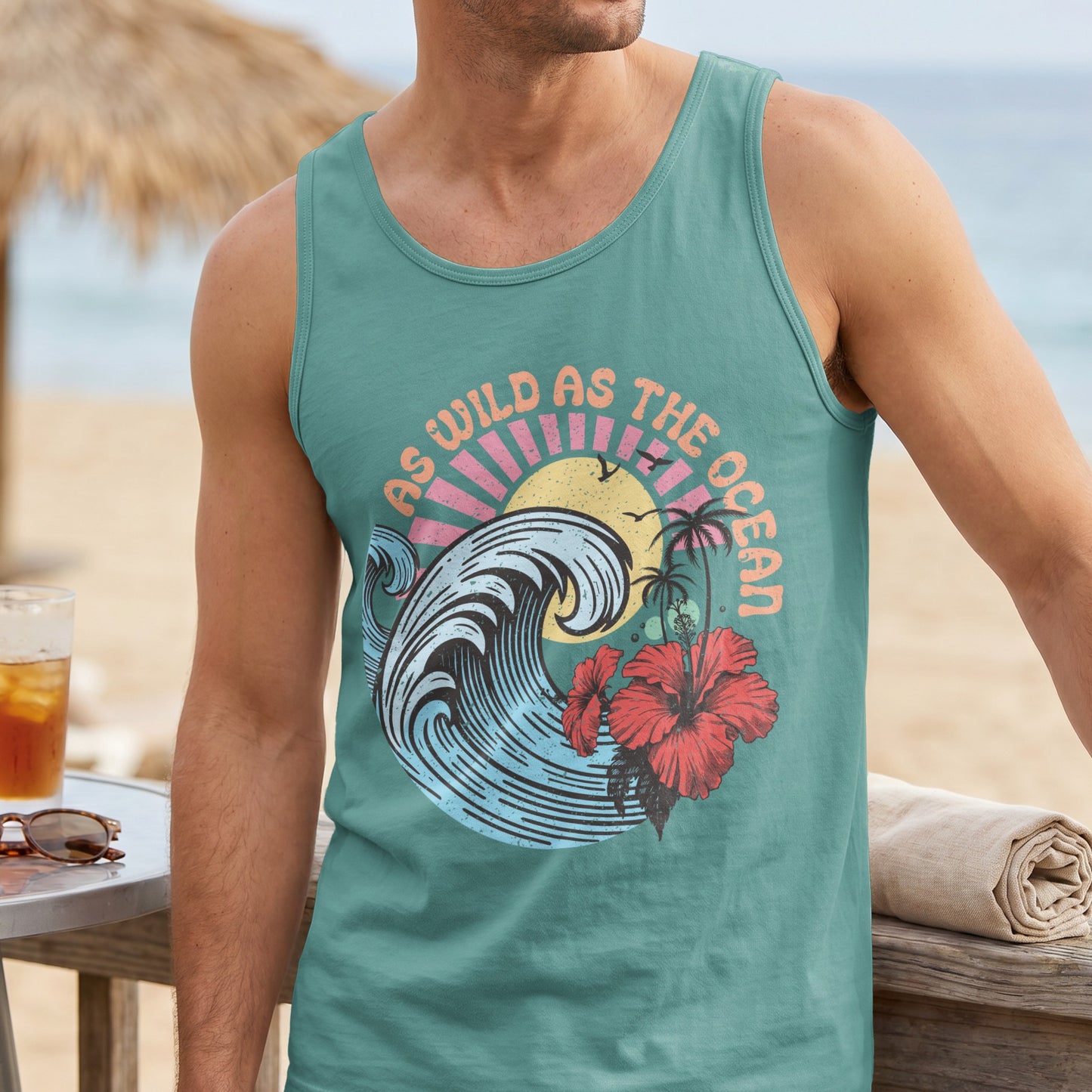 Teal tank top with tropical wave and hibiscus design, reads "As wild as the ocean."