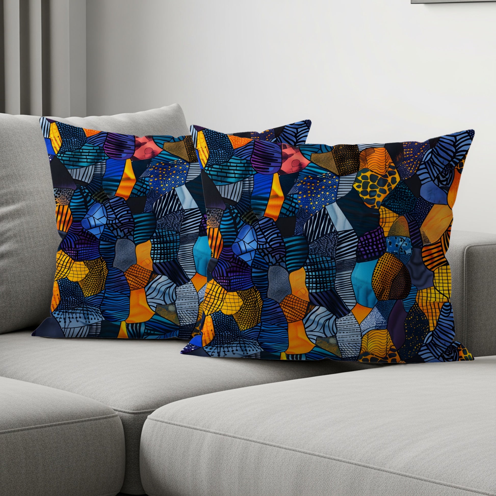 Two rectangular pillows with a vibrant patchwork design of abstract shapes and patterns.