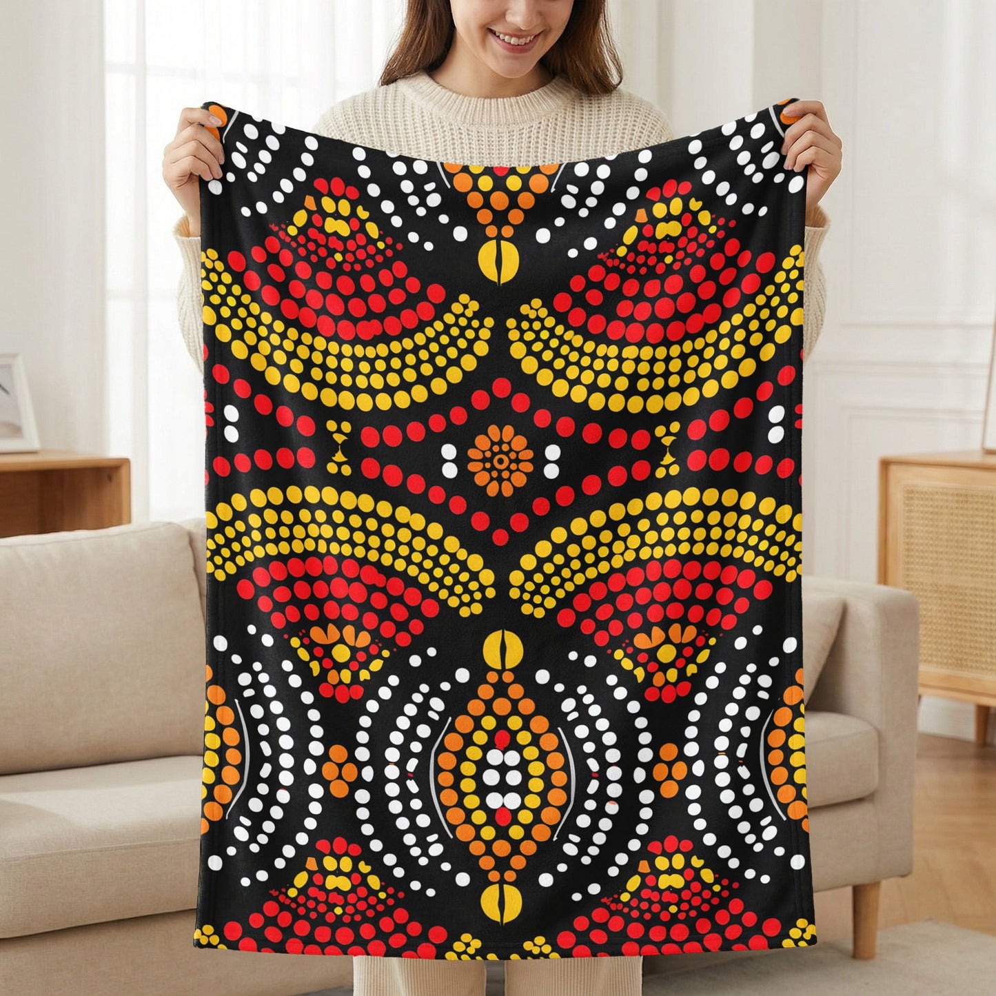 Black blanket with red, yellow, and white dot art geometric pattern.