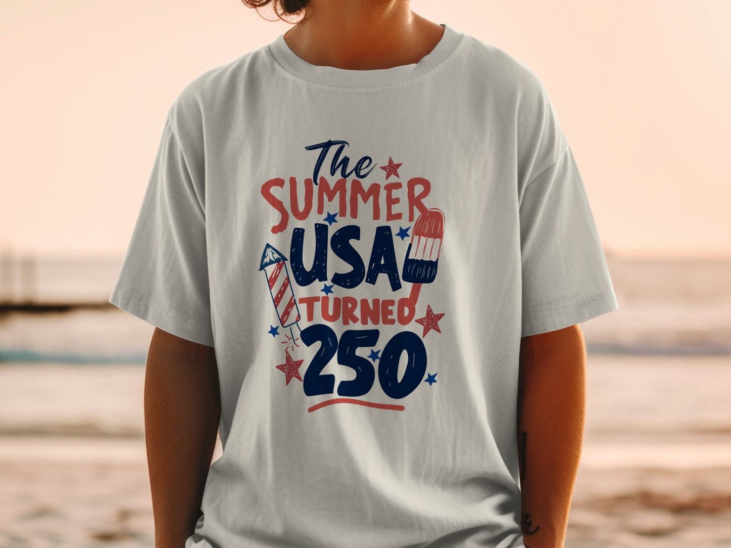 T-shirt with "The Summer USA Turned 250" text and patriotic graphics.