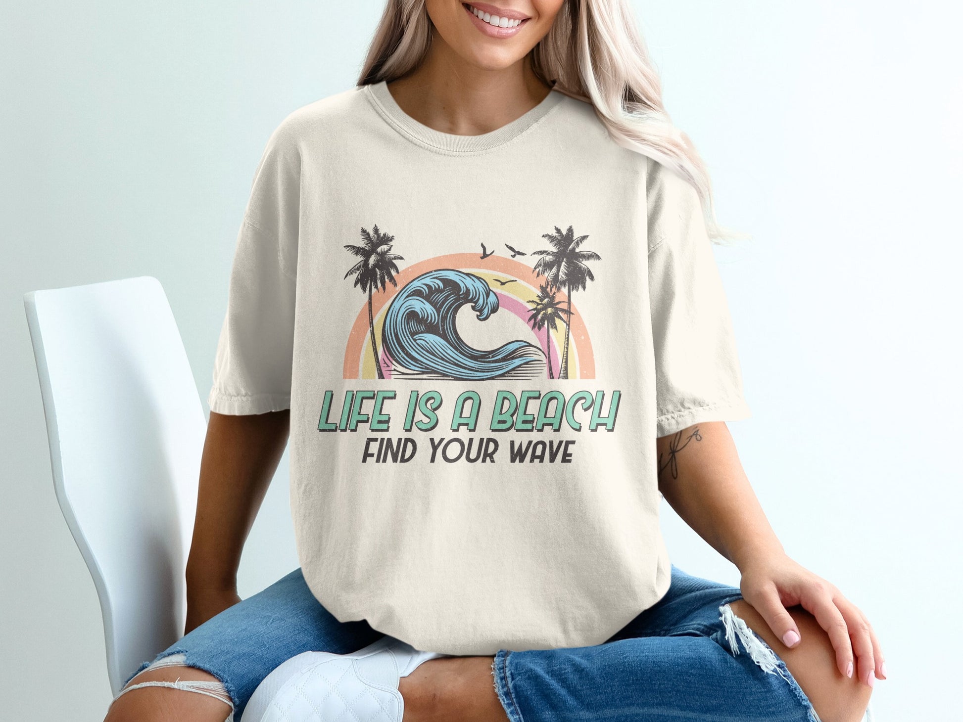 T-shirt with "Life is a Beach Find Your Wave" text, waves, and palm trees.