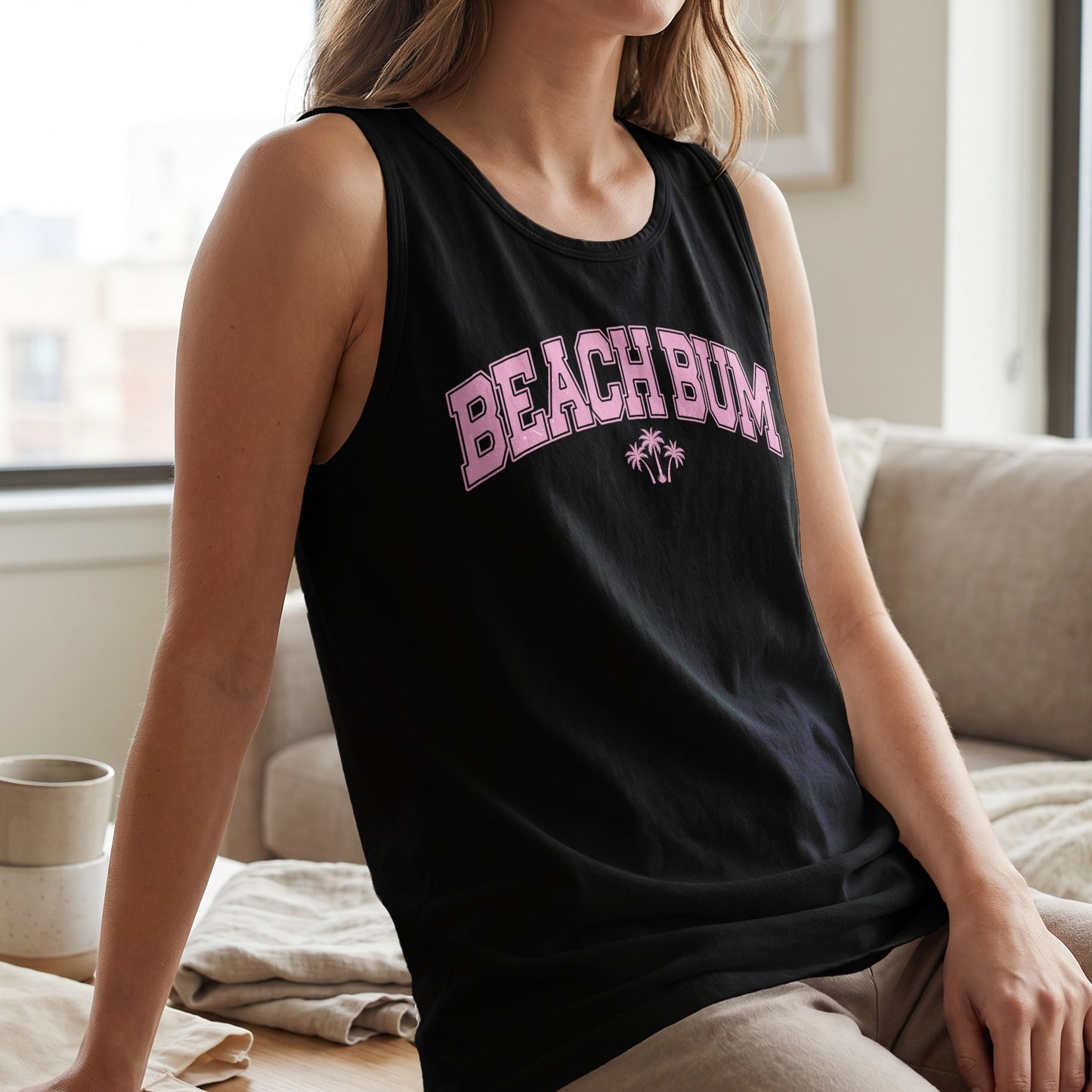 Black tank top with "BEACH BUM" text in pink and palm trees.
