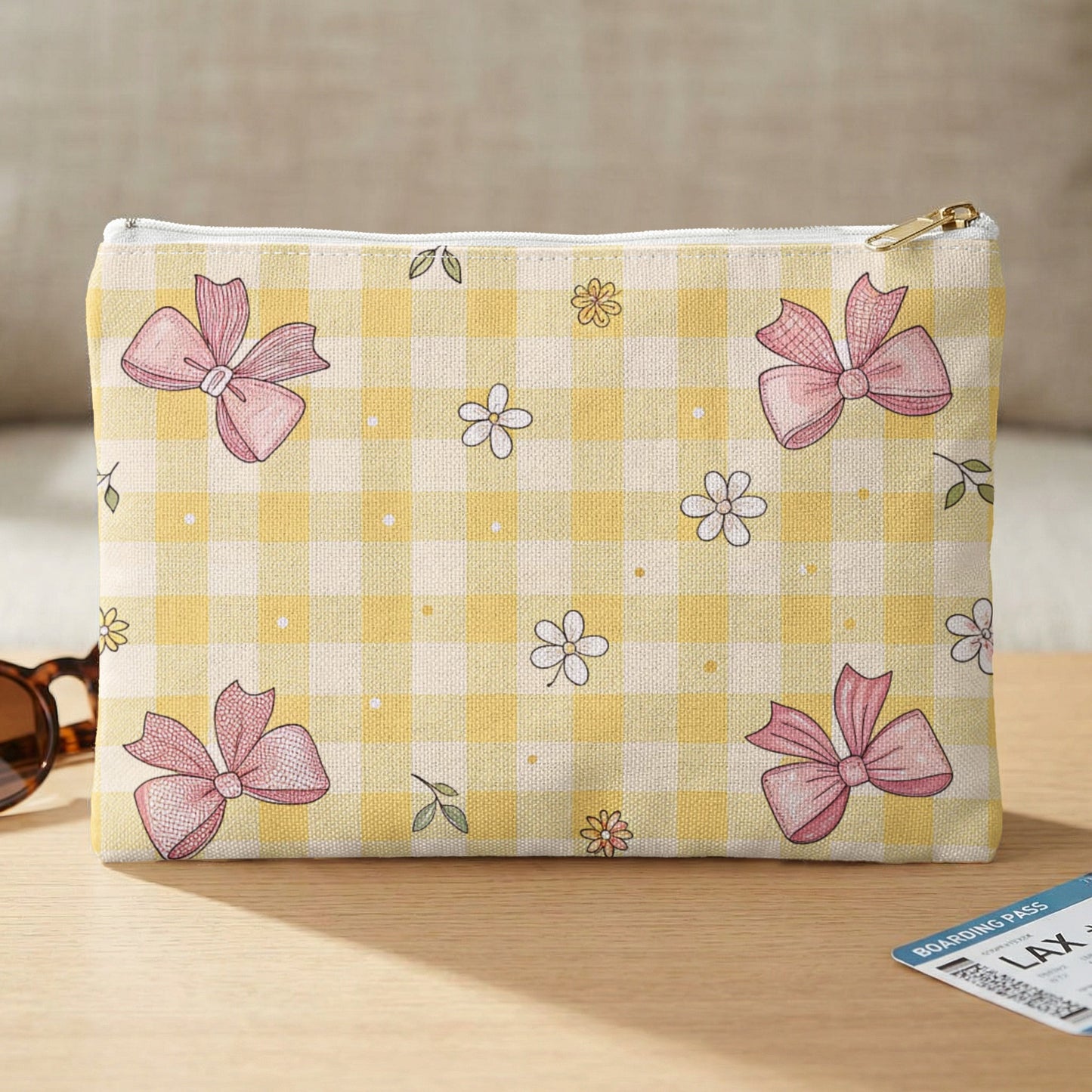 Yellow gingham pouch with pink bows and scattered daisies.