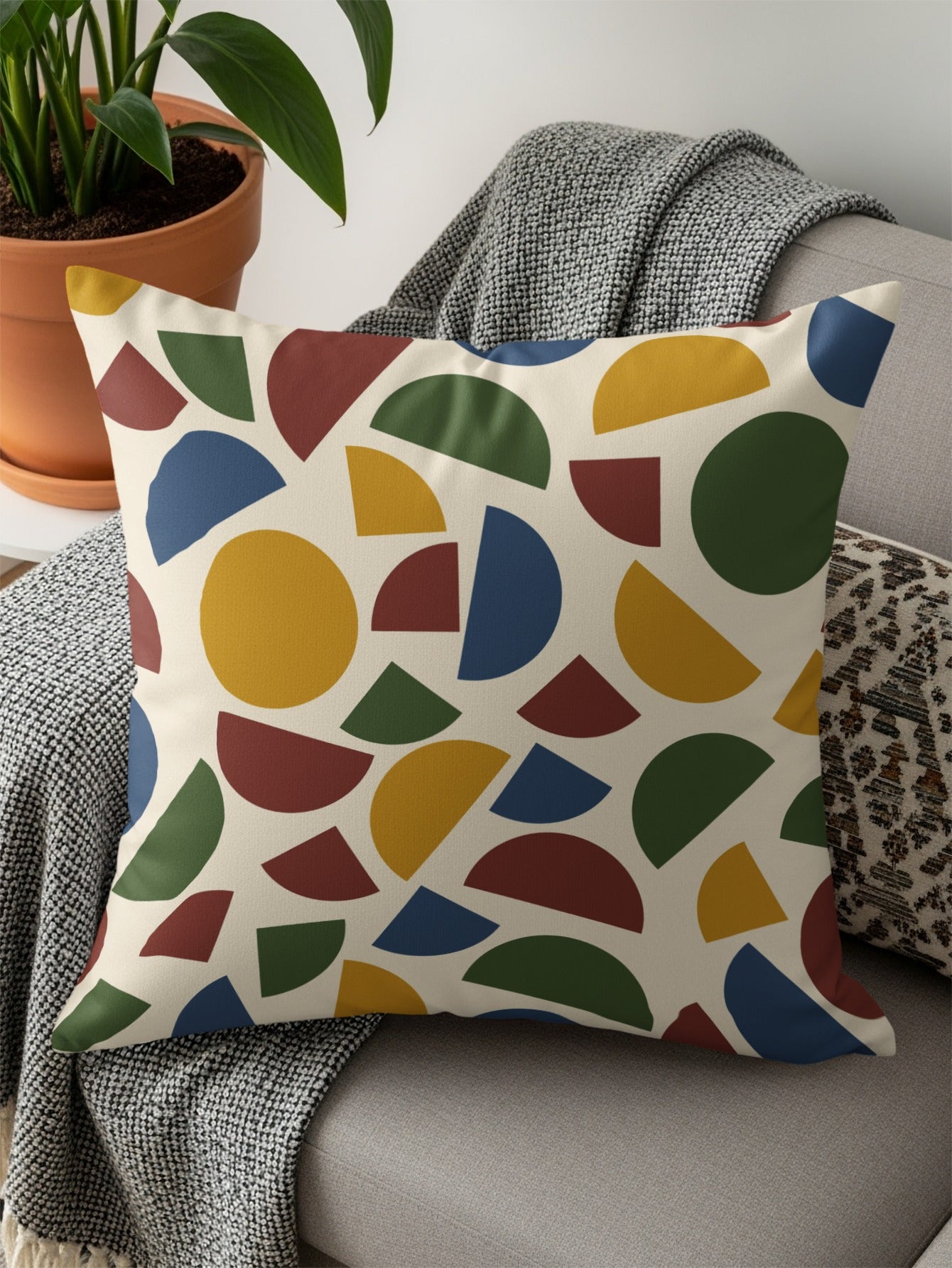 Throw pillow with abstract geometric pattern of circles and semi-circles.