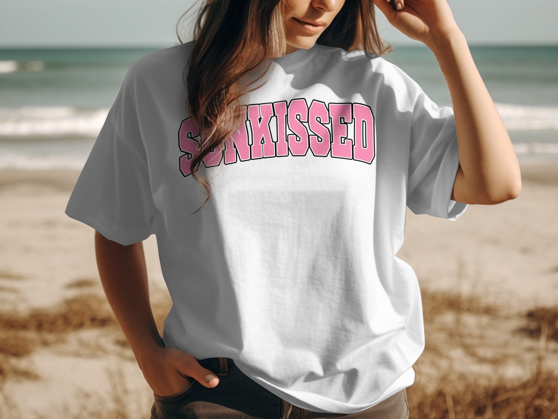 White t-shirt with pink "SUNKISSED" text across the chest.