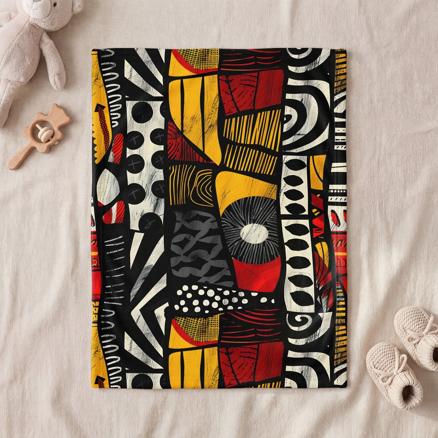 Blanket with abstract black, white, red, and yellow graphic print.