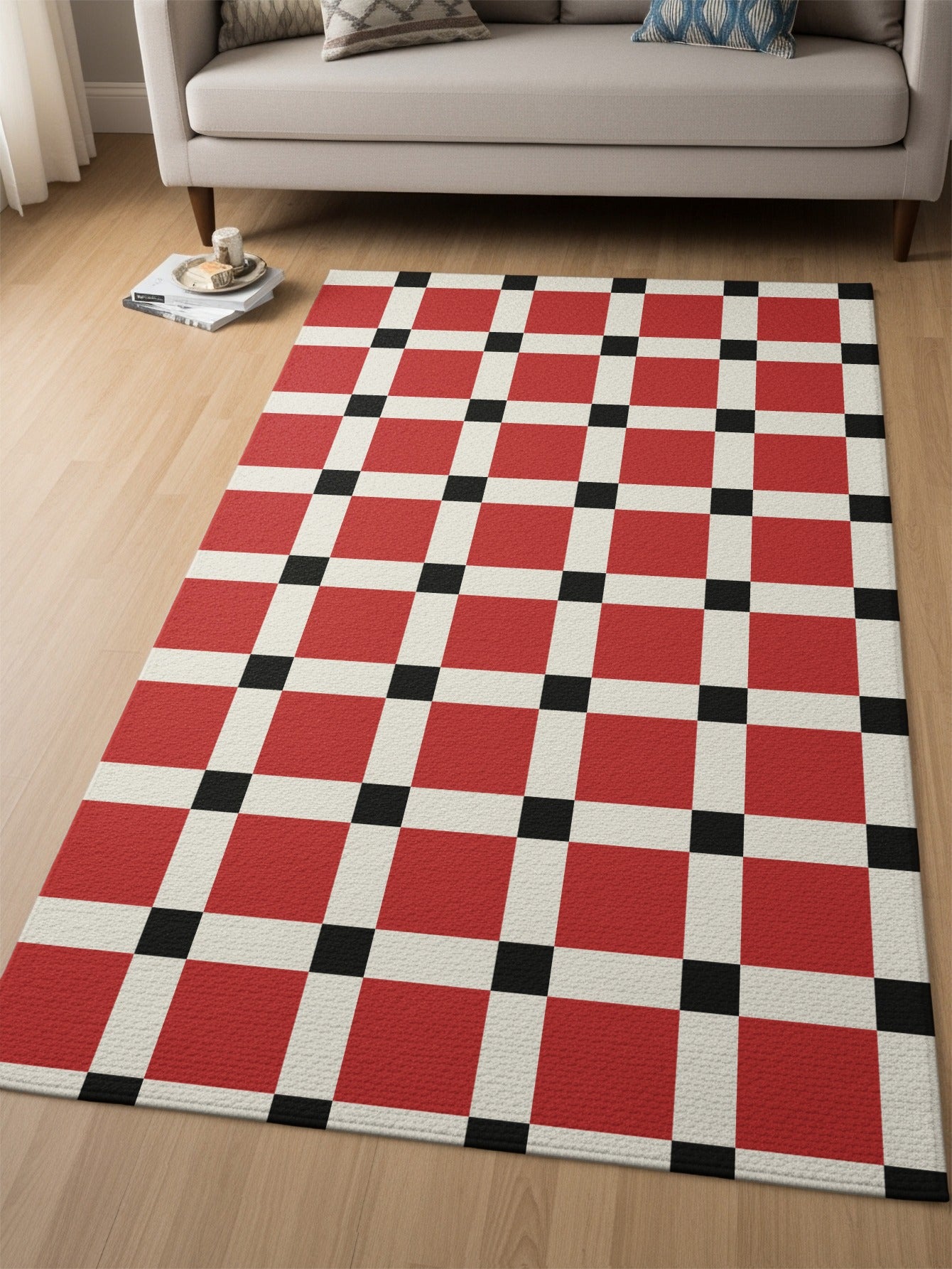 Red, black, and white checkerboard rug on a wood floor.