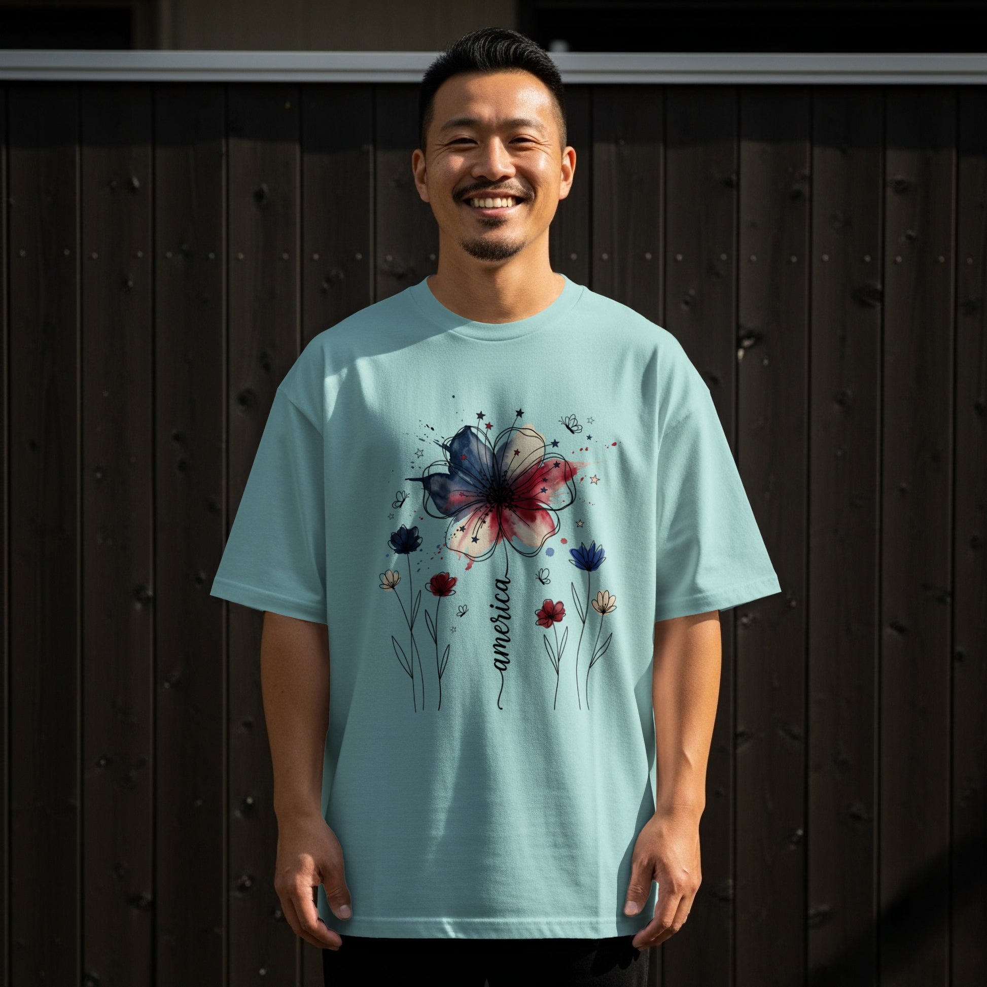 Light blue t-shirt with watercolor flower design and "America" text.