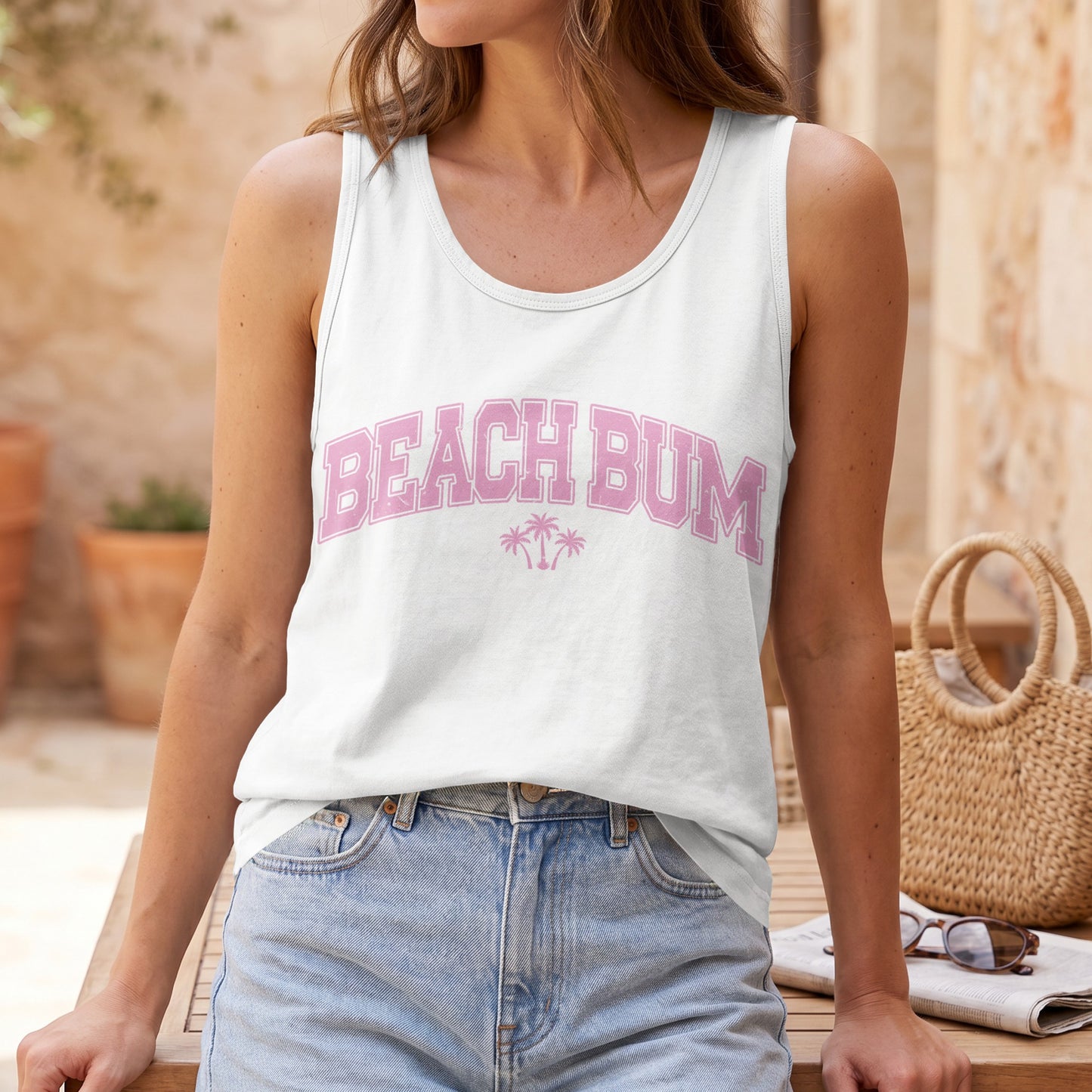 White tank top with "BEACH BUM" in pink lettering and palm trees.