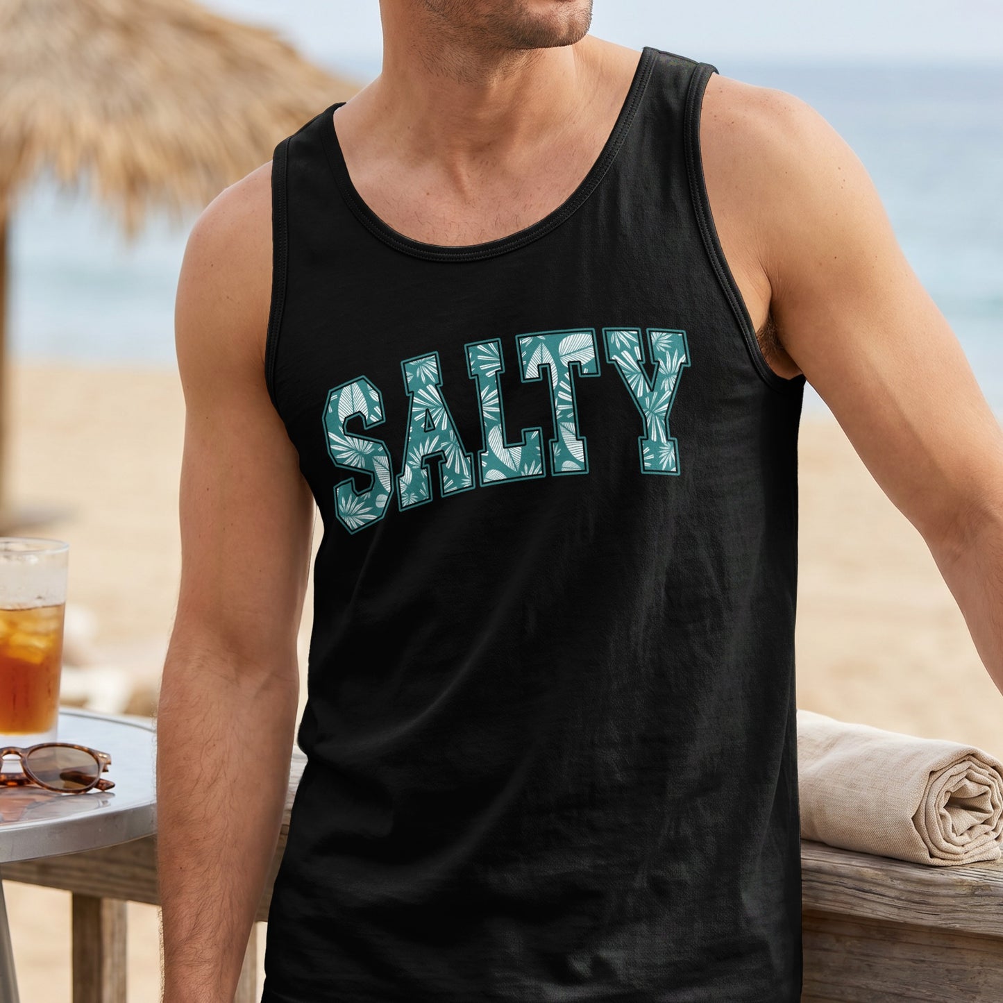 Black tank top with "Salty" text featuring a tropical leaf pattern.