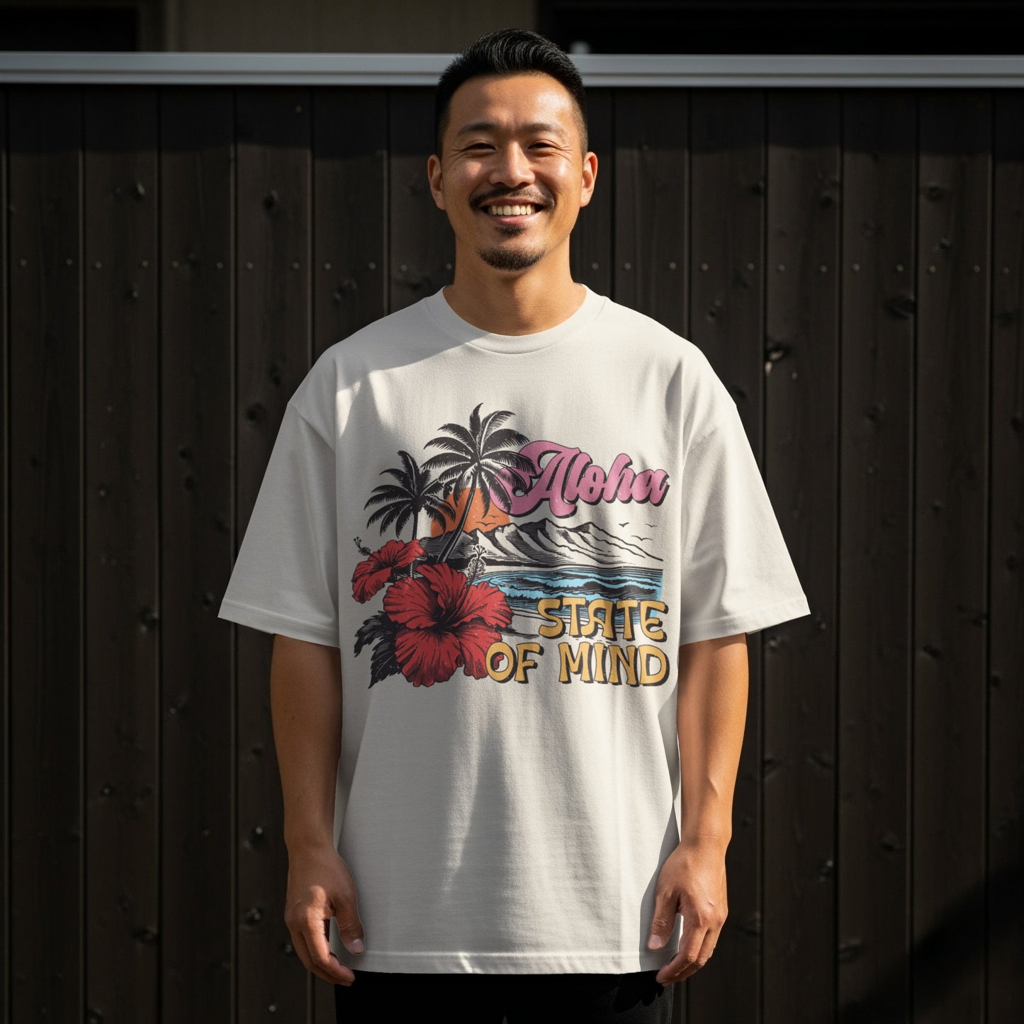 Man in white t-shirt with Aloha State of Mind beach graphic.