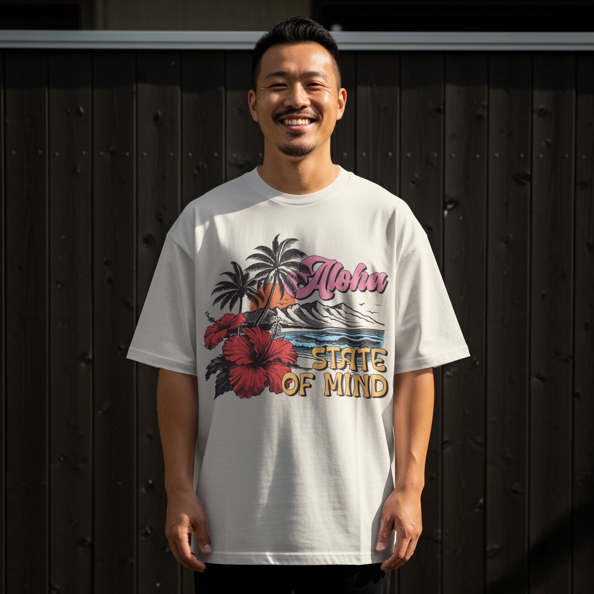 Man in white t-shirt with Aloha State of Mind beach graphic.