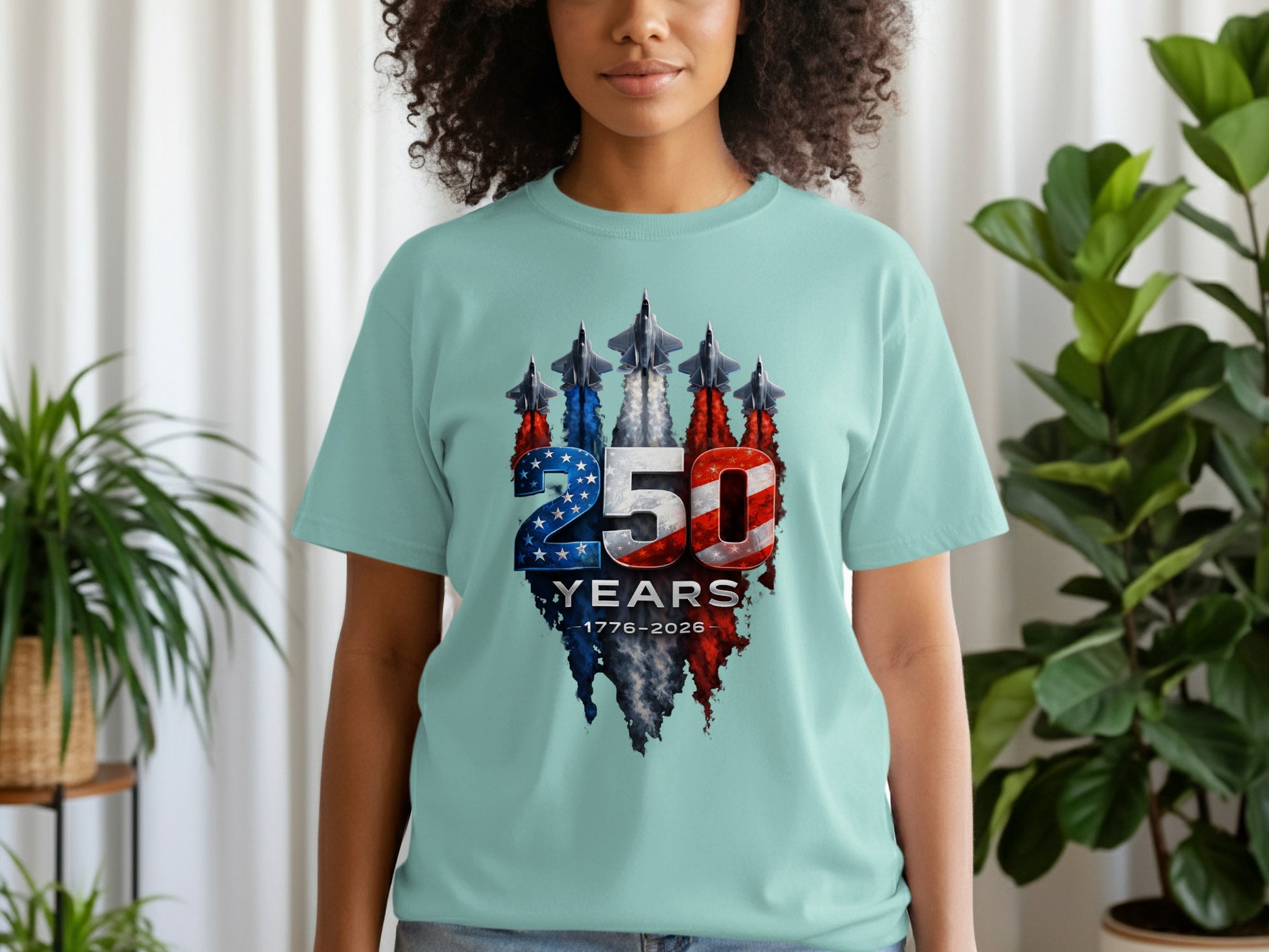 Light blue t-shirt with a graphic of fighter jets and "250 YEARS 1776-2026" text.