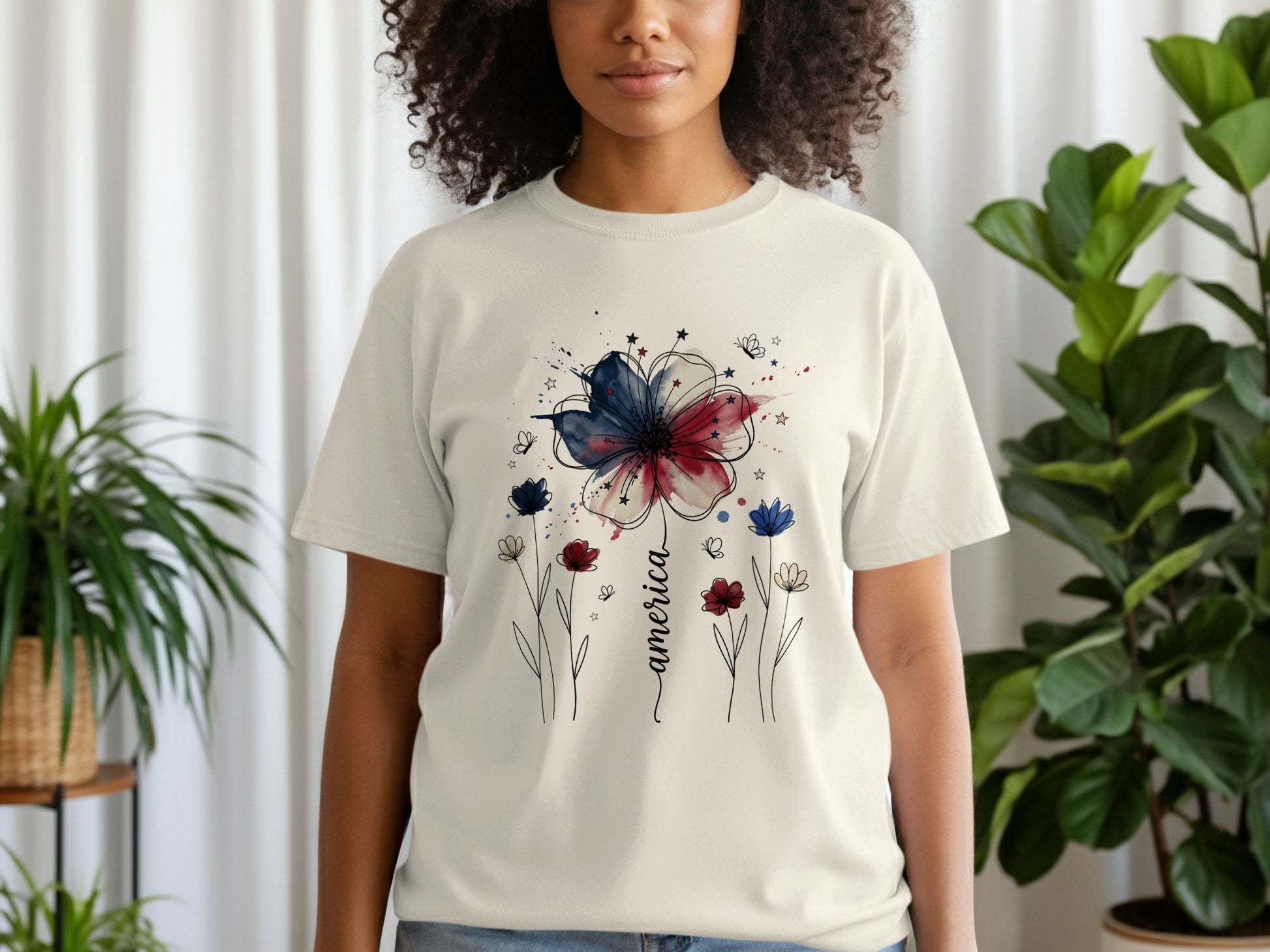 Cream t-shirt with patriotic floral design and "America" text.