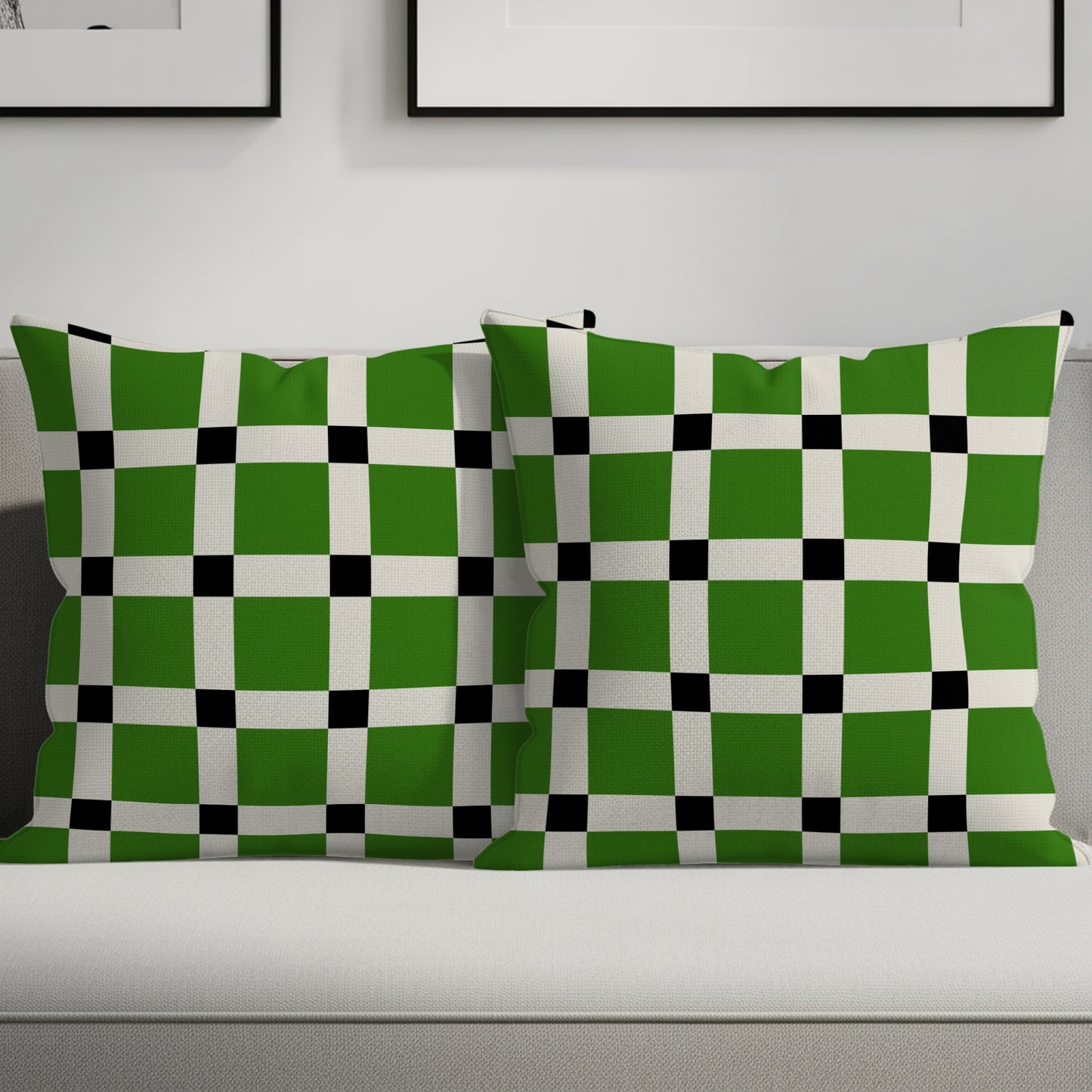 Two green, white, and black checkered throw pillows on a sofa.