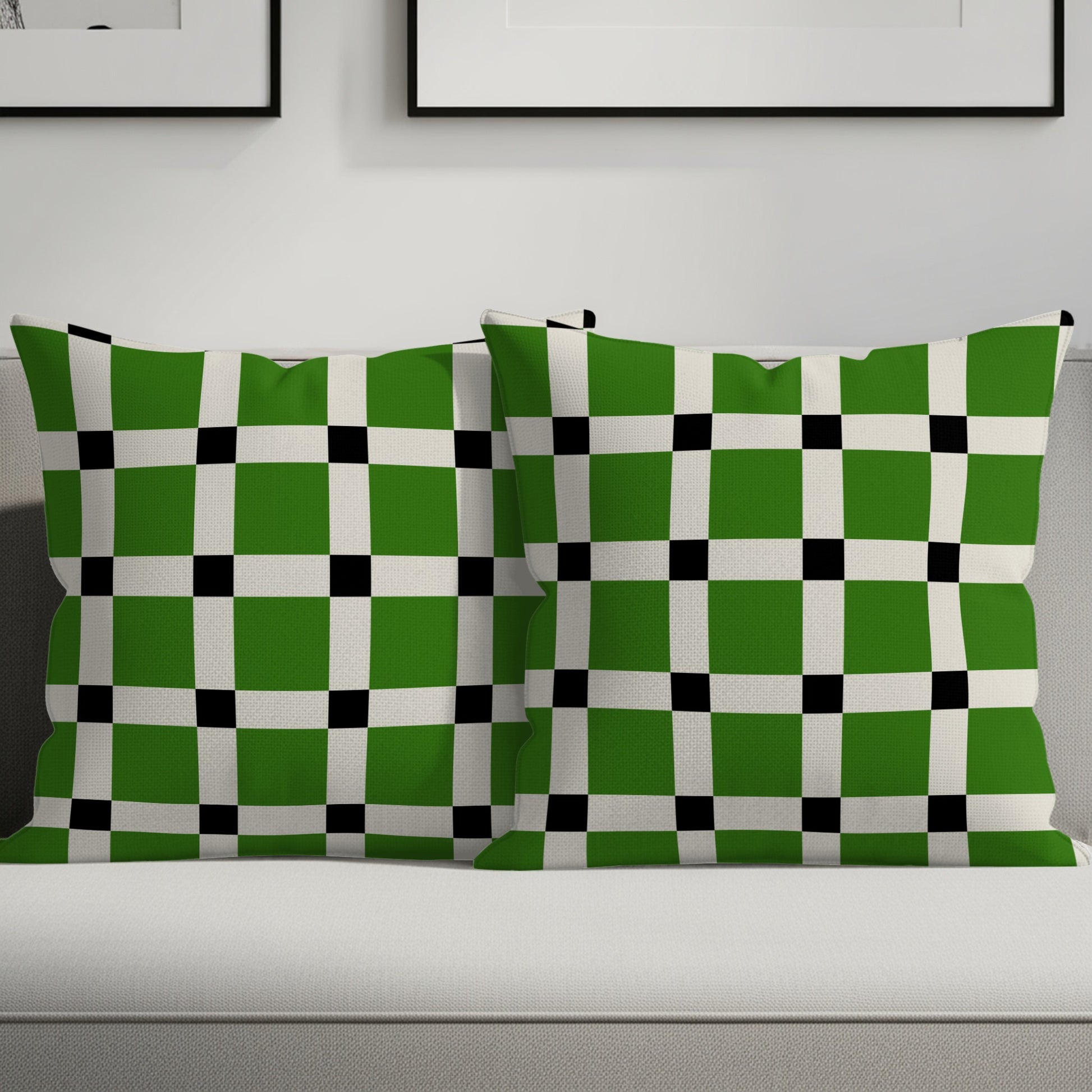 Two green, white, and black checkered throw pillows on a sofa.