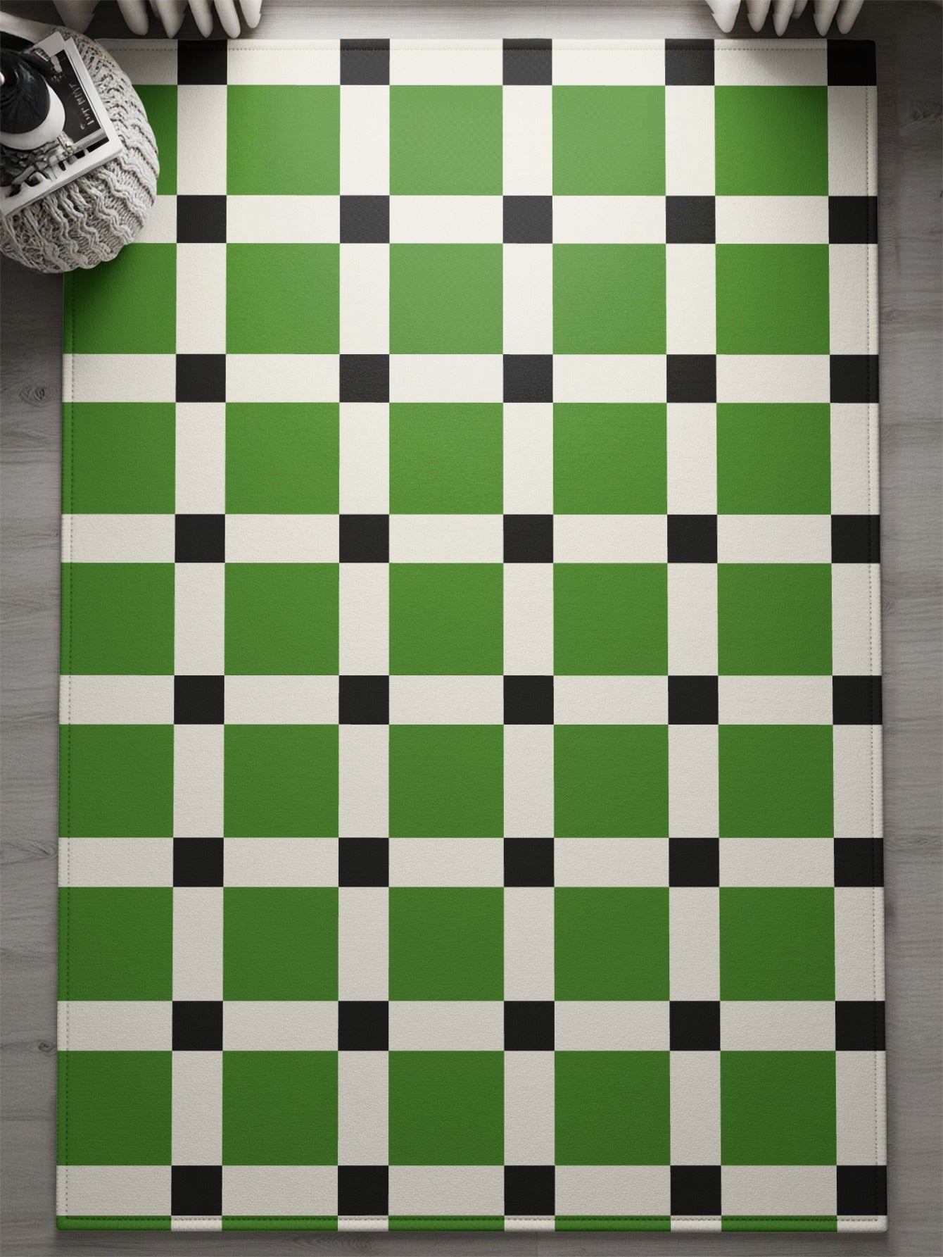 Green and white checkered rug with black squares at intersections.