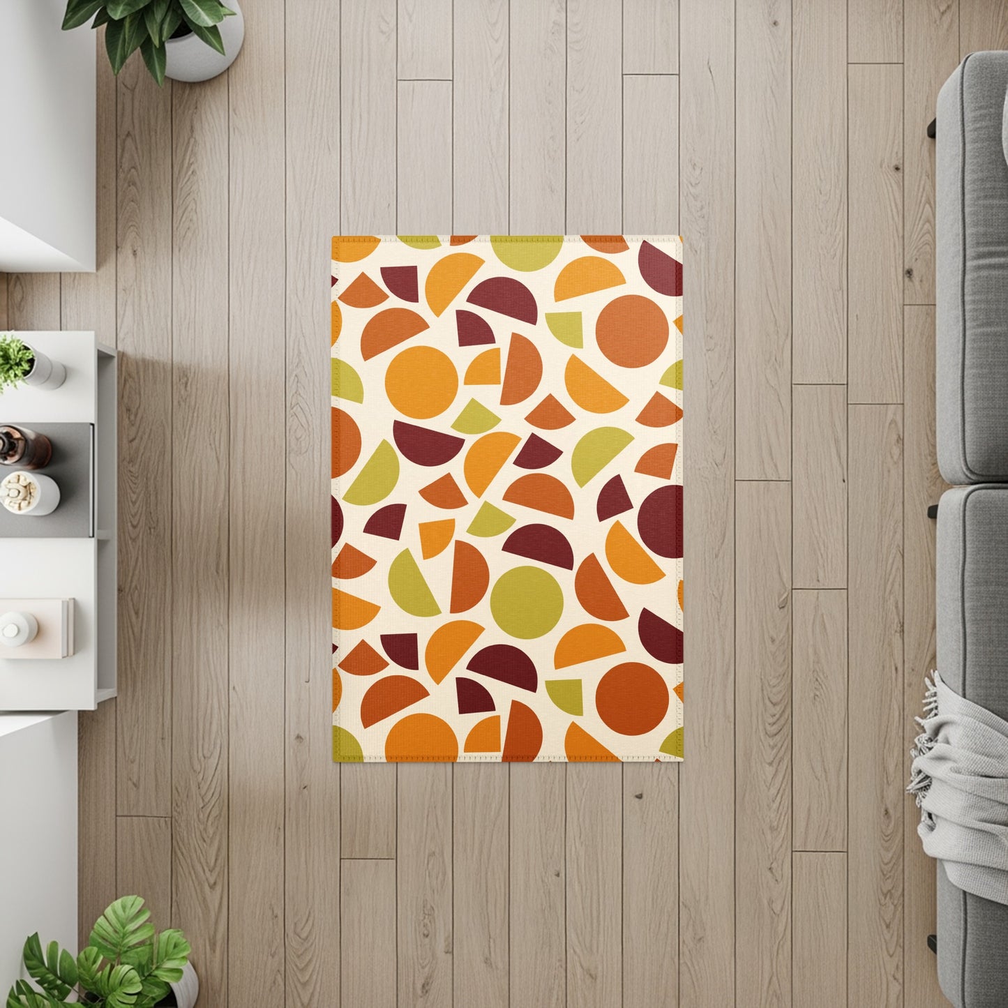 Rectangular rug with cream background and scattered circles and semicircles in orange, brown, and green.