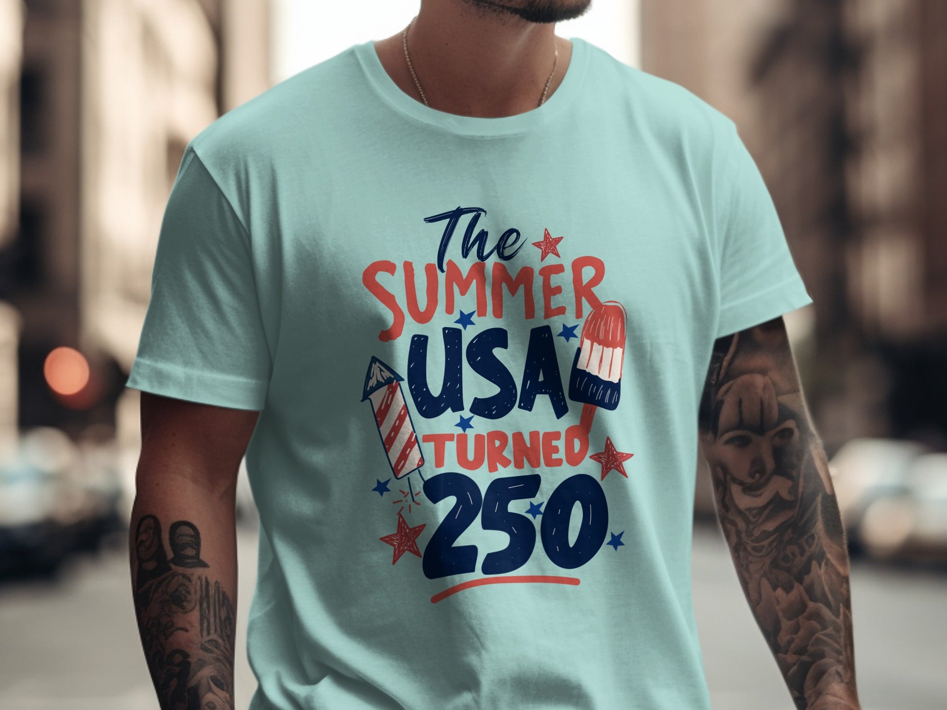 Light blue t-shirt with "The Summer USA Turned 250" text and patriotic graphics.