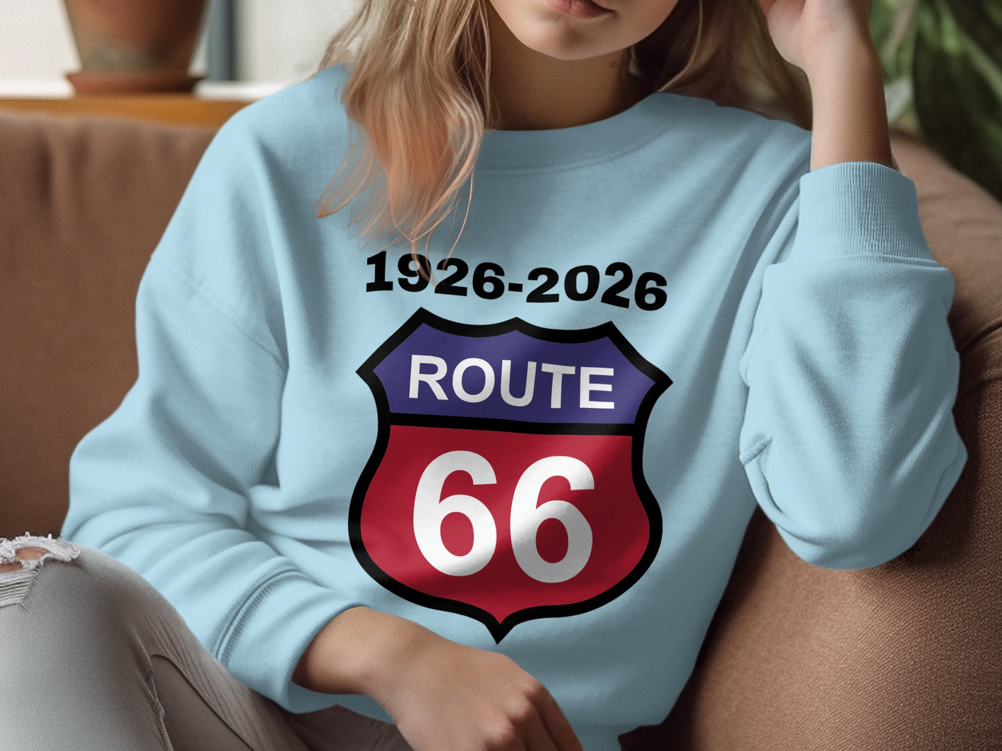Light blue sweatshirt with "Route 66" shield logo and "1926-2026" text.