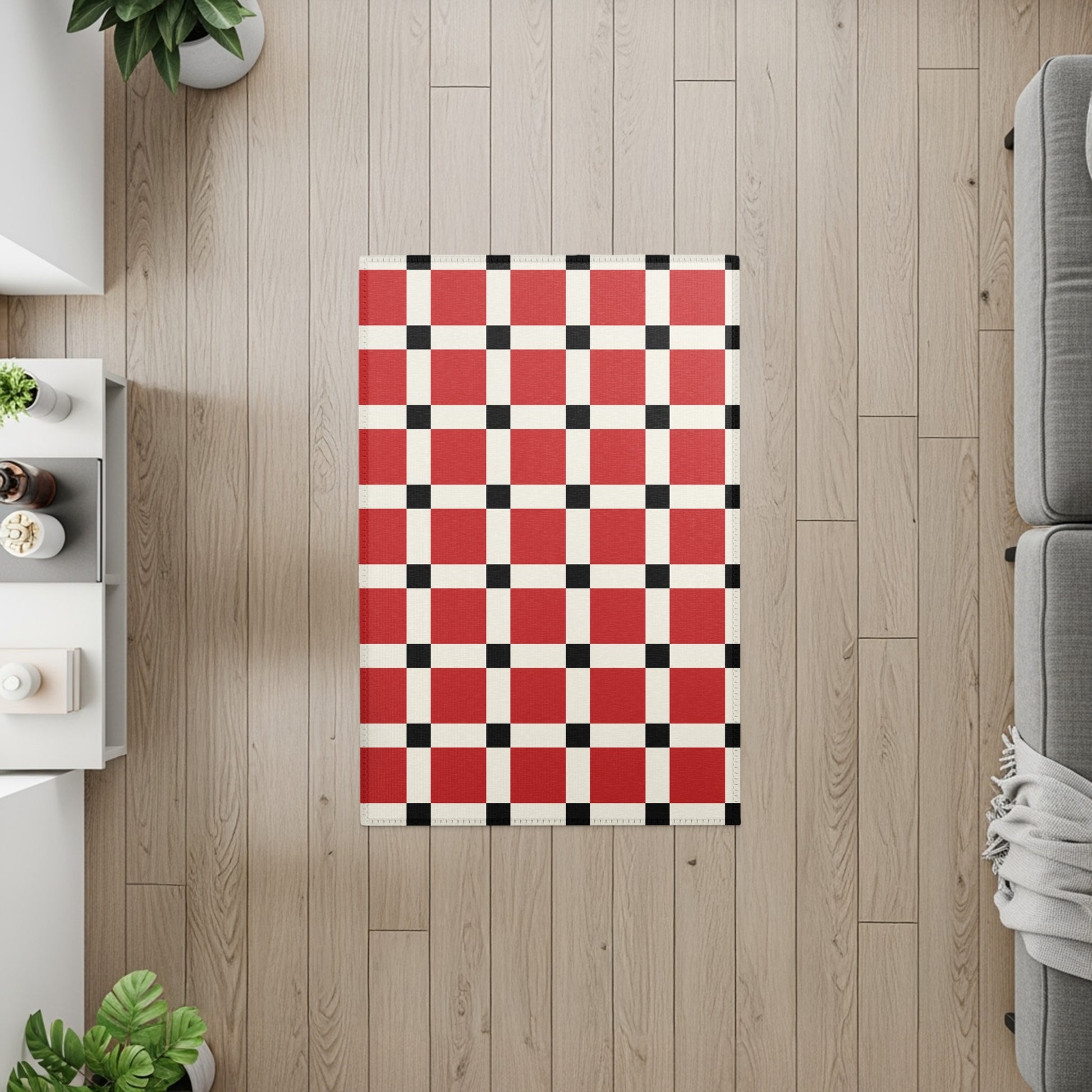 Red, white, and black checkerboard rug on light wood floor with sofa and furniture.