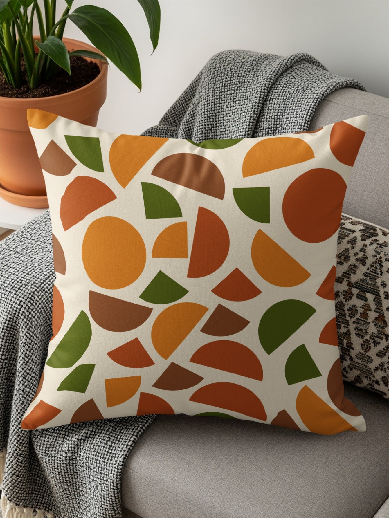Throw pillow with cream background and mid-century modern abstract geometric pattern.