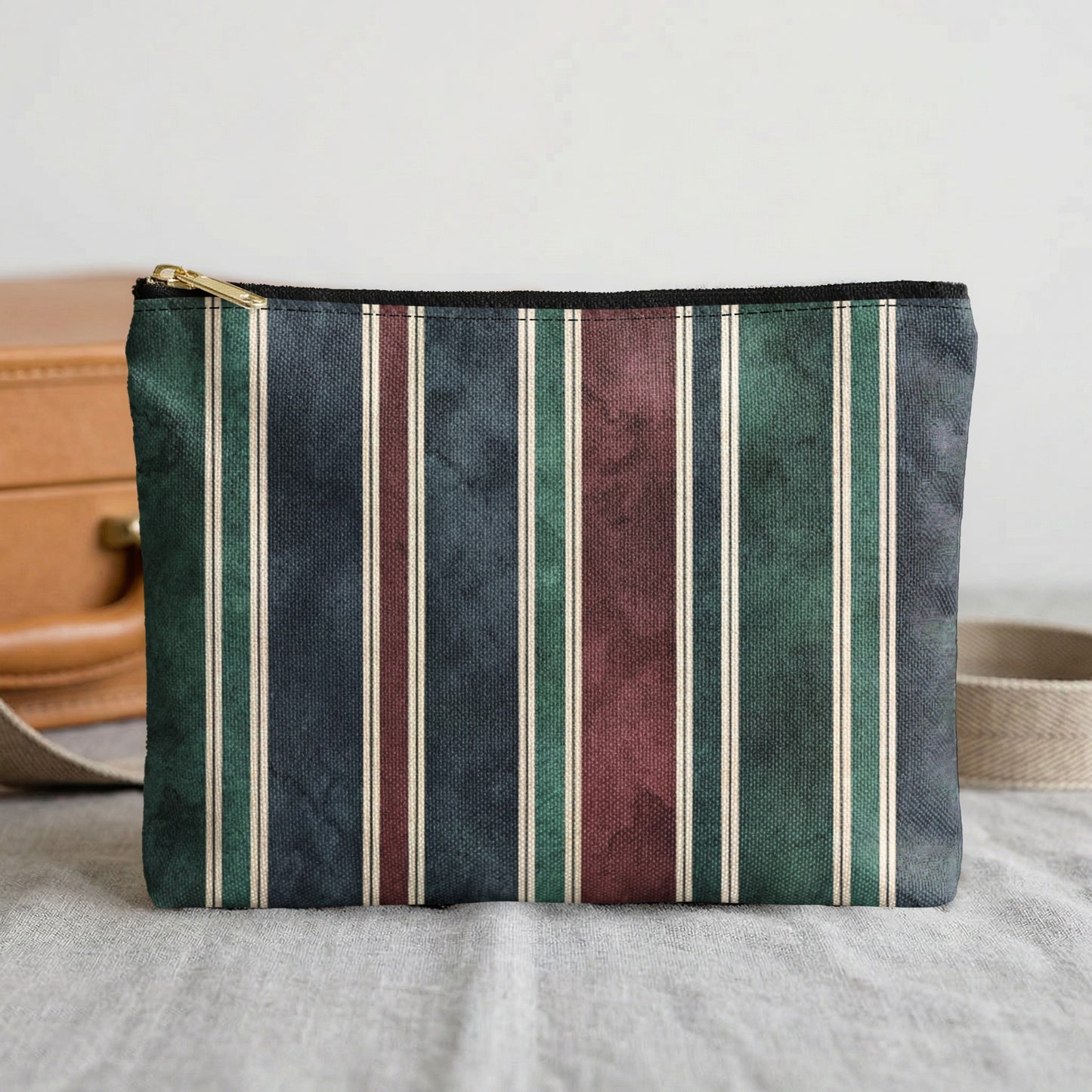 Clutch bag with vertical stripes in navy, green, maroon, and cream.