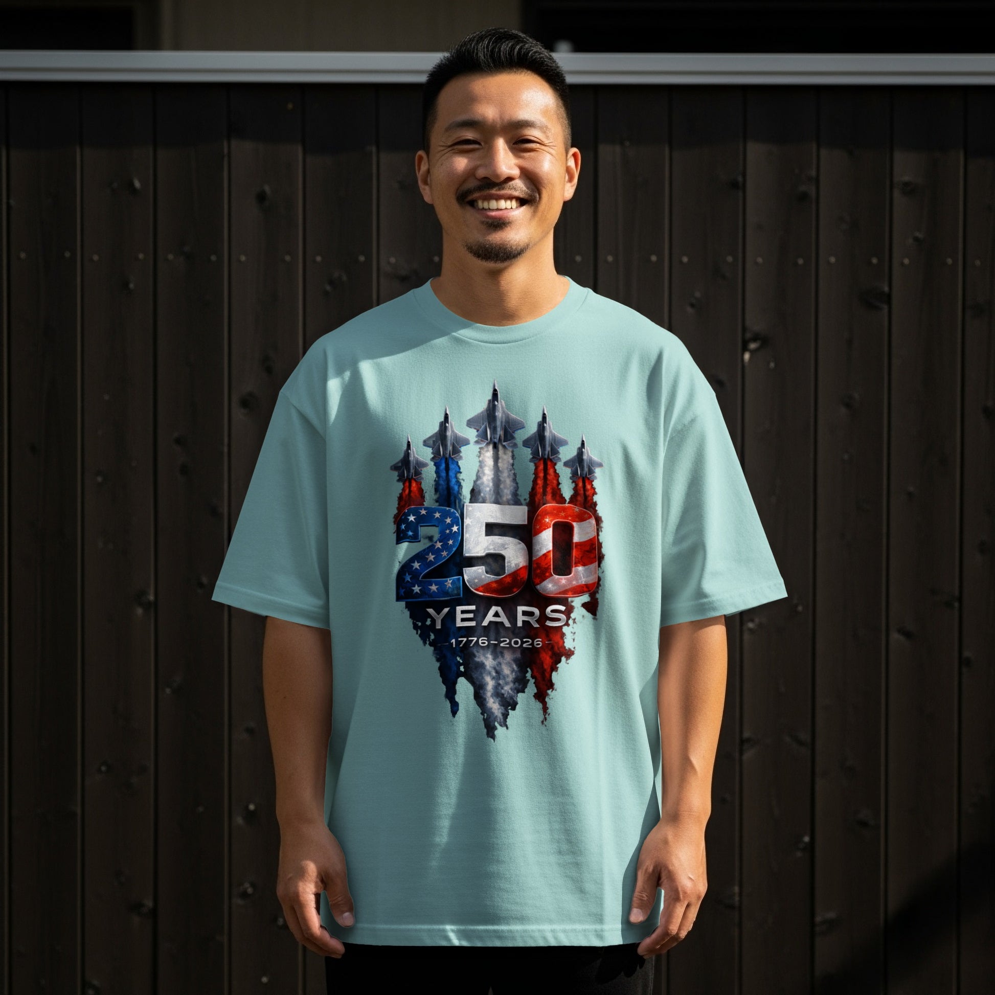 Man wearing light blue t-shirt with "250 1776-2026" patriotic graphic.