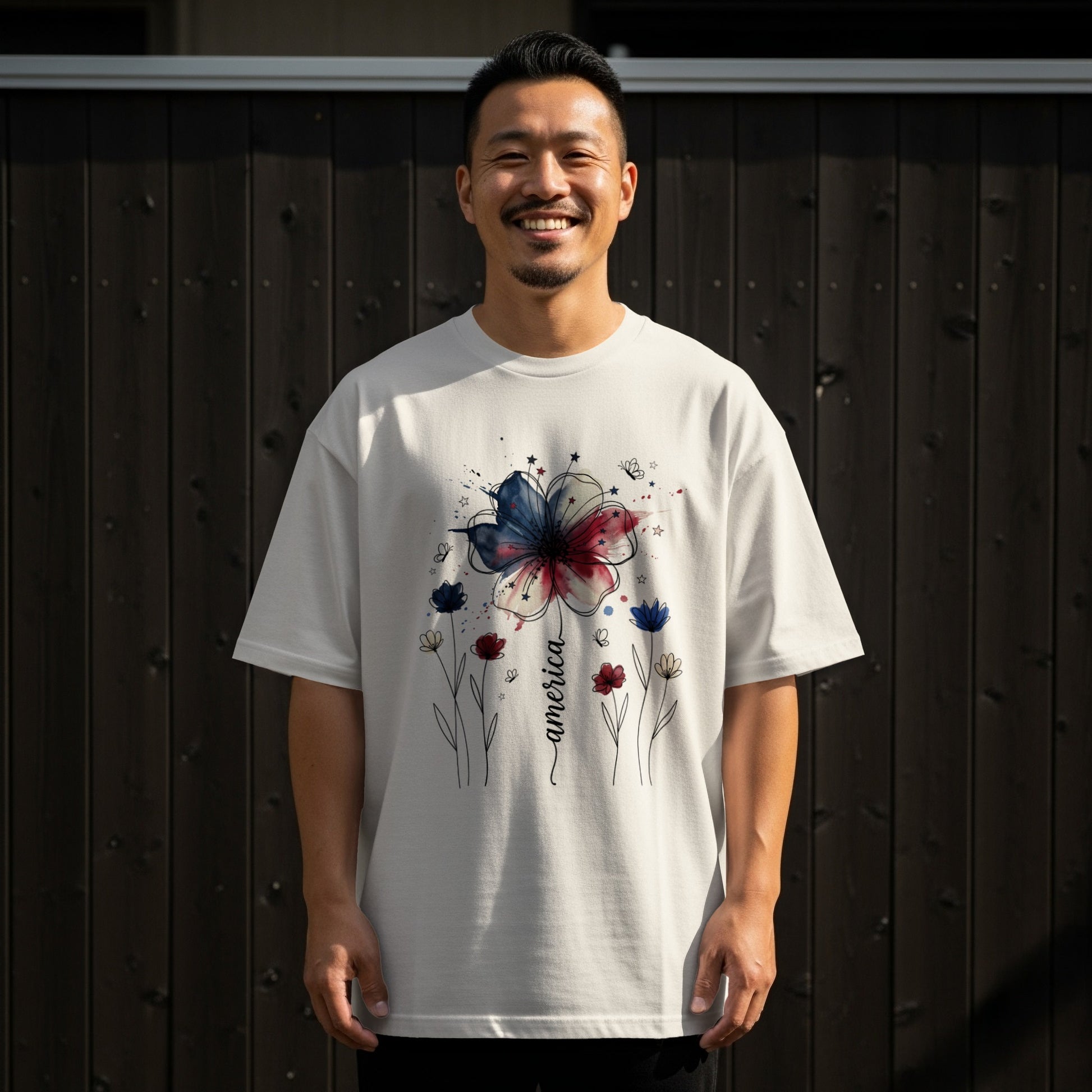 Man wearing white t-shirt with America floral graphic.