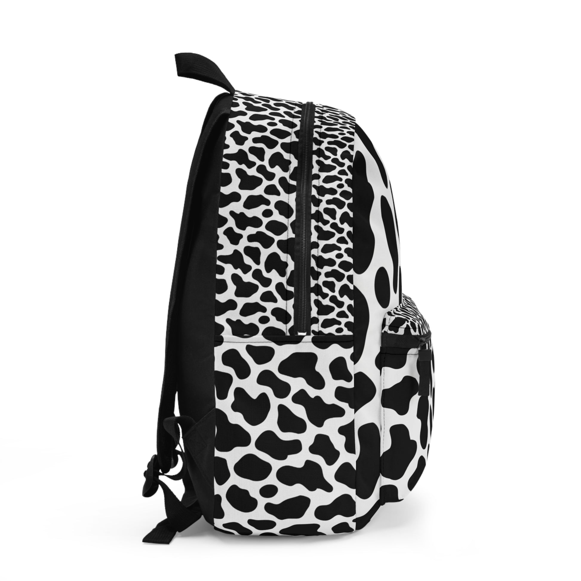 Black backpack on white background with black and white cow print pattern.