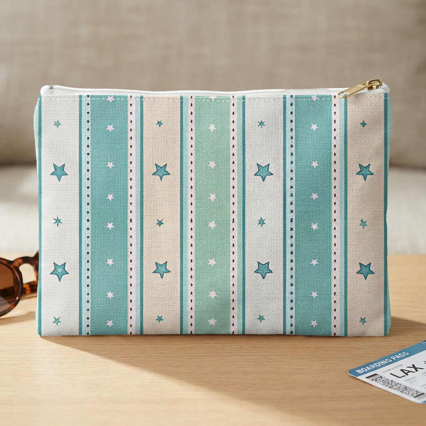 Cosmetic bag with teal, white, and beige stripes and small pink and teal stars.