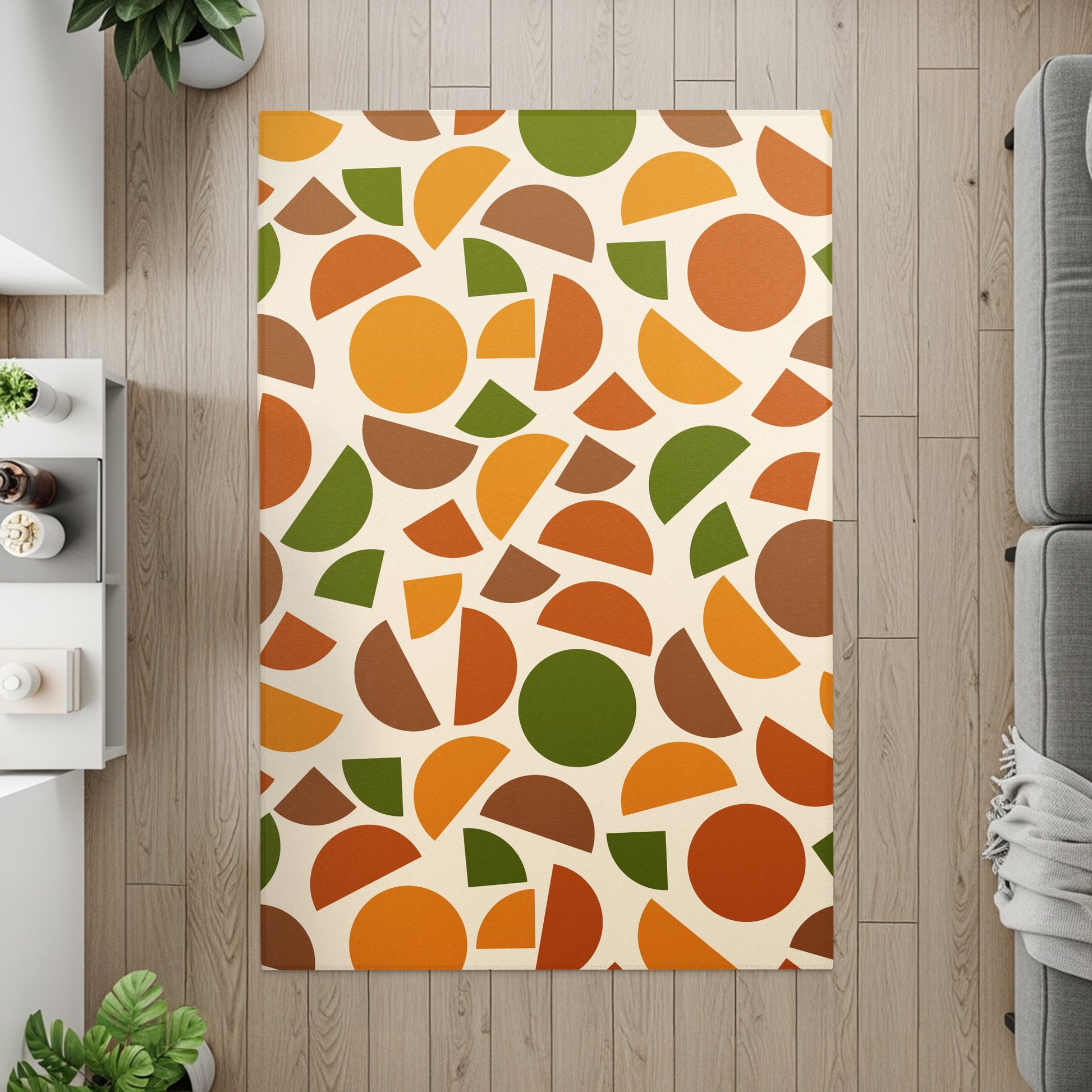 Rug with abstract Mid-Century Modern-style shapes in orange, green, and brown on cream background.