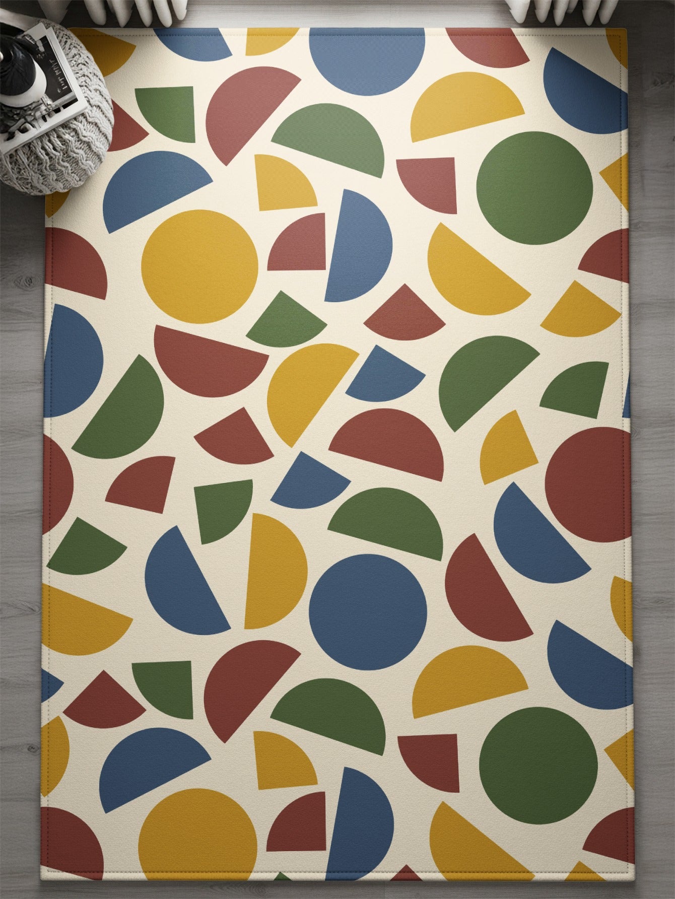 Rug with cream background and scattered colorful geometric shapes including circles and semicircles.